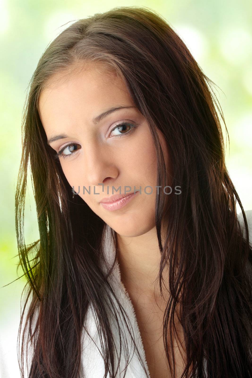 Young woman in white bathtub against abstract green background