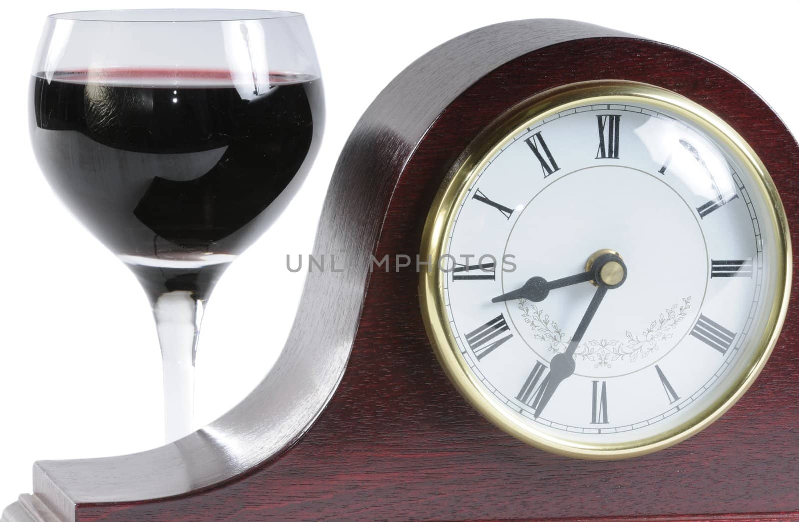 mantle clock and a glass of wine symbolising time for a drink