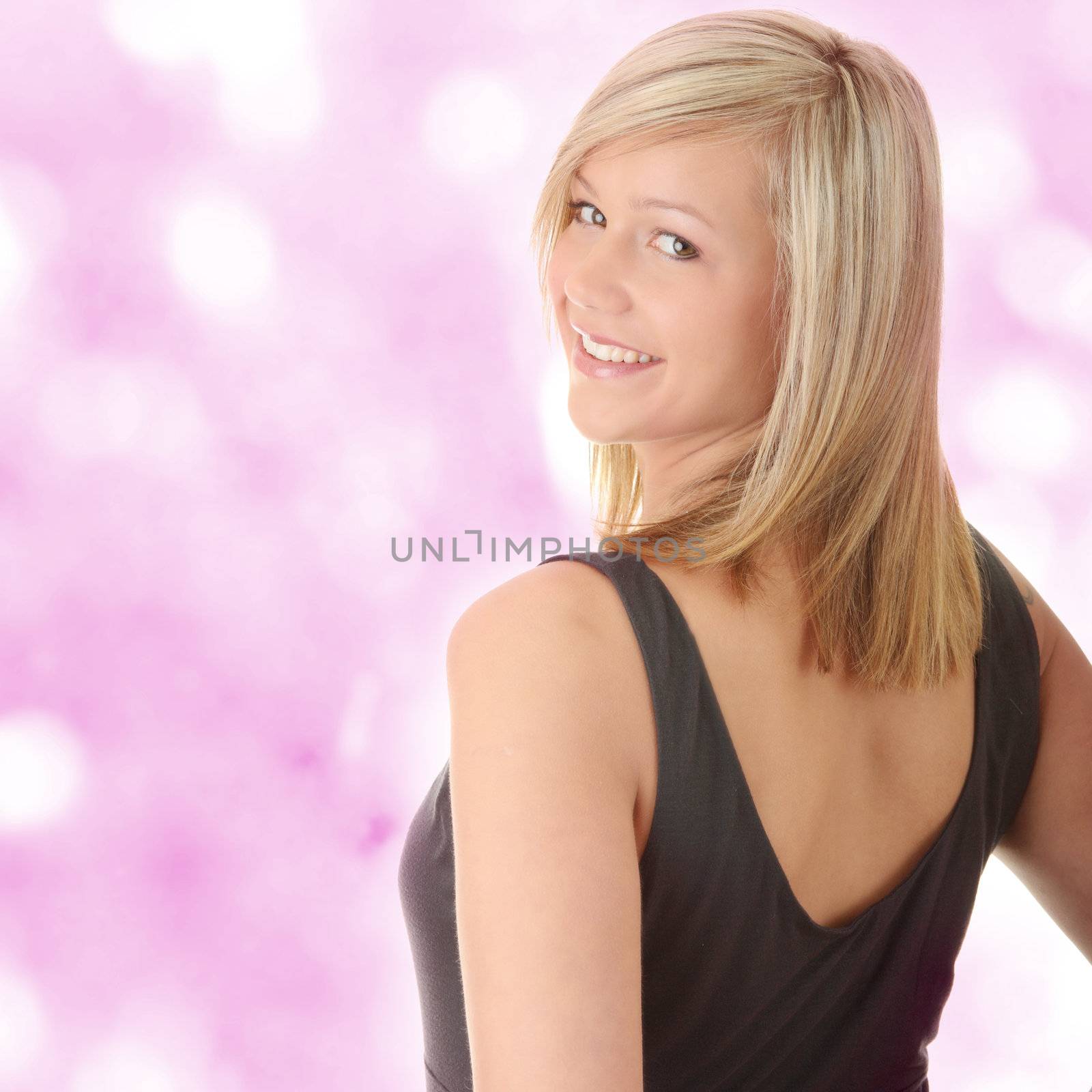 Beautiful teenager young blond girl in black elegant dress over abstract background