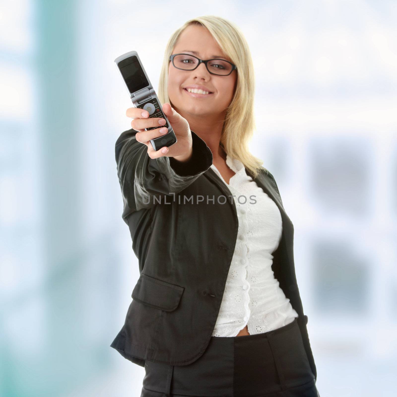 Attractive young business women with cellular phone - focus on phone