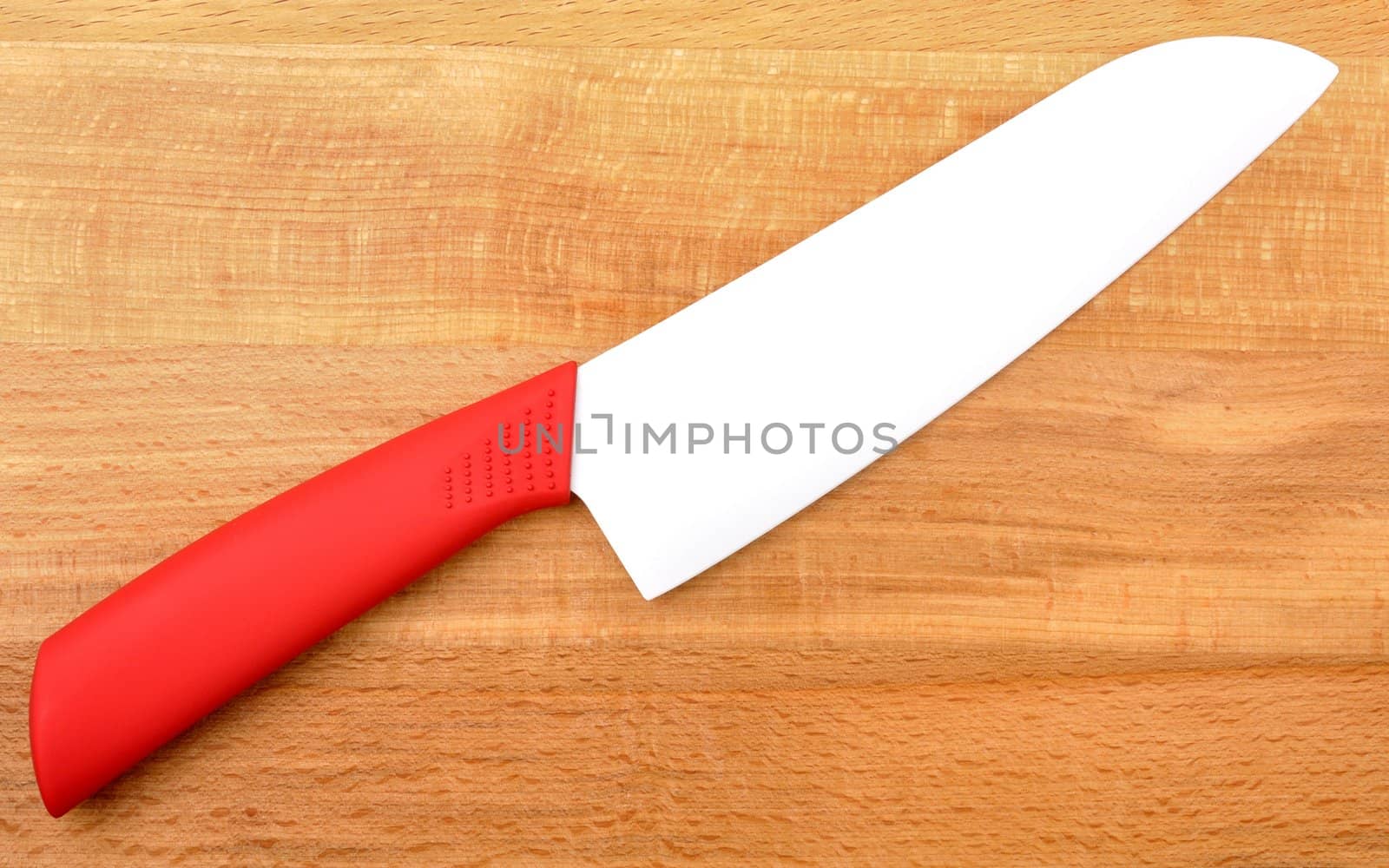 ceramic knife on wooden background