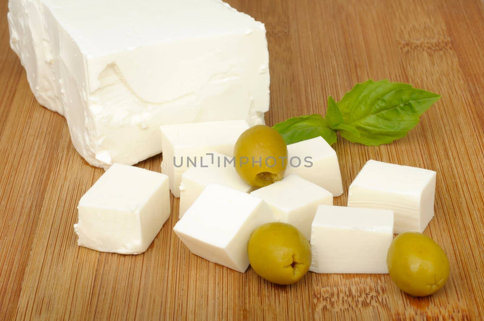 feta cheese and olives on a cutting board