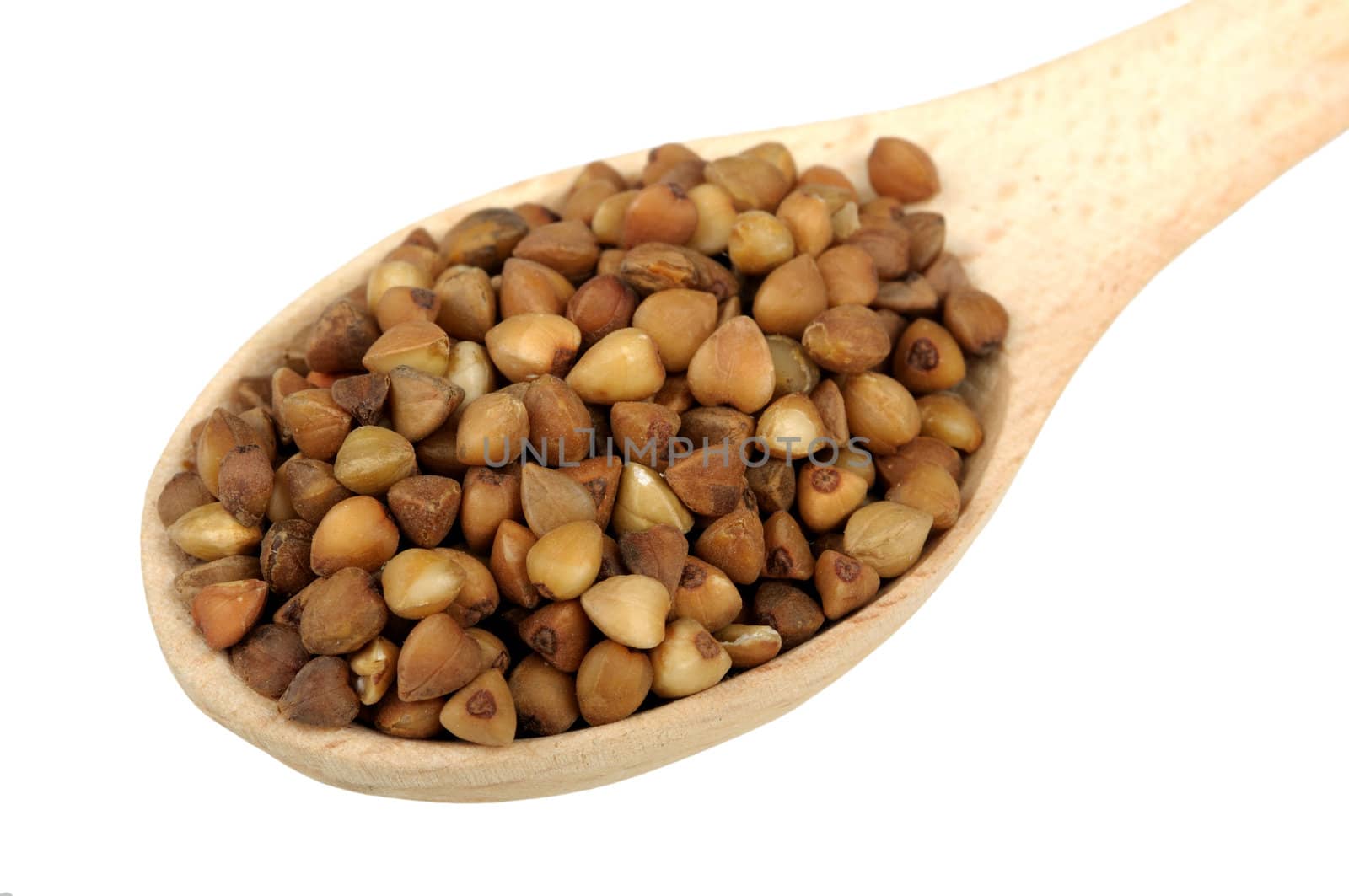 buckwheat in a wooden spoon isolated on white background