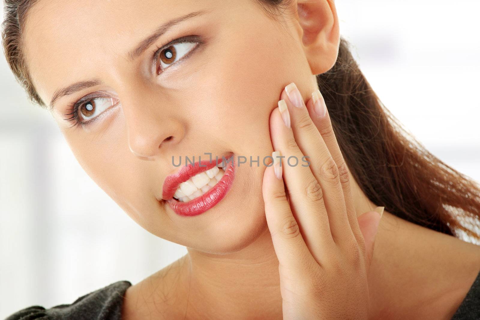 Young woman in pain is having toothache