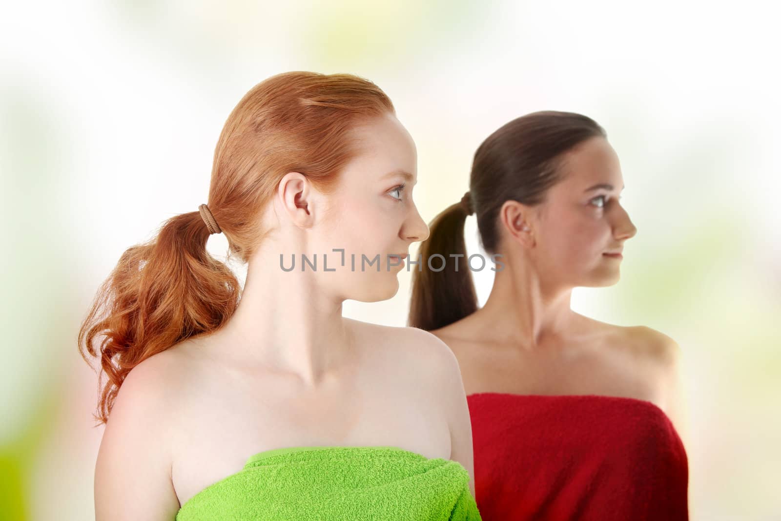 Spa - portrait of two woman - redhead and brunette - looking right