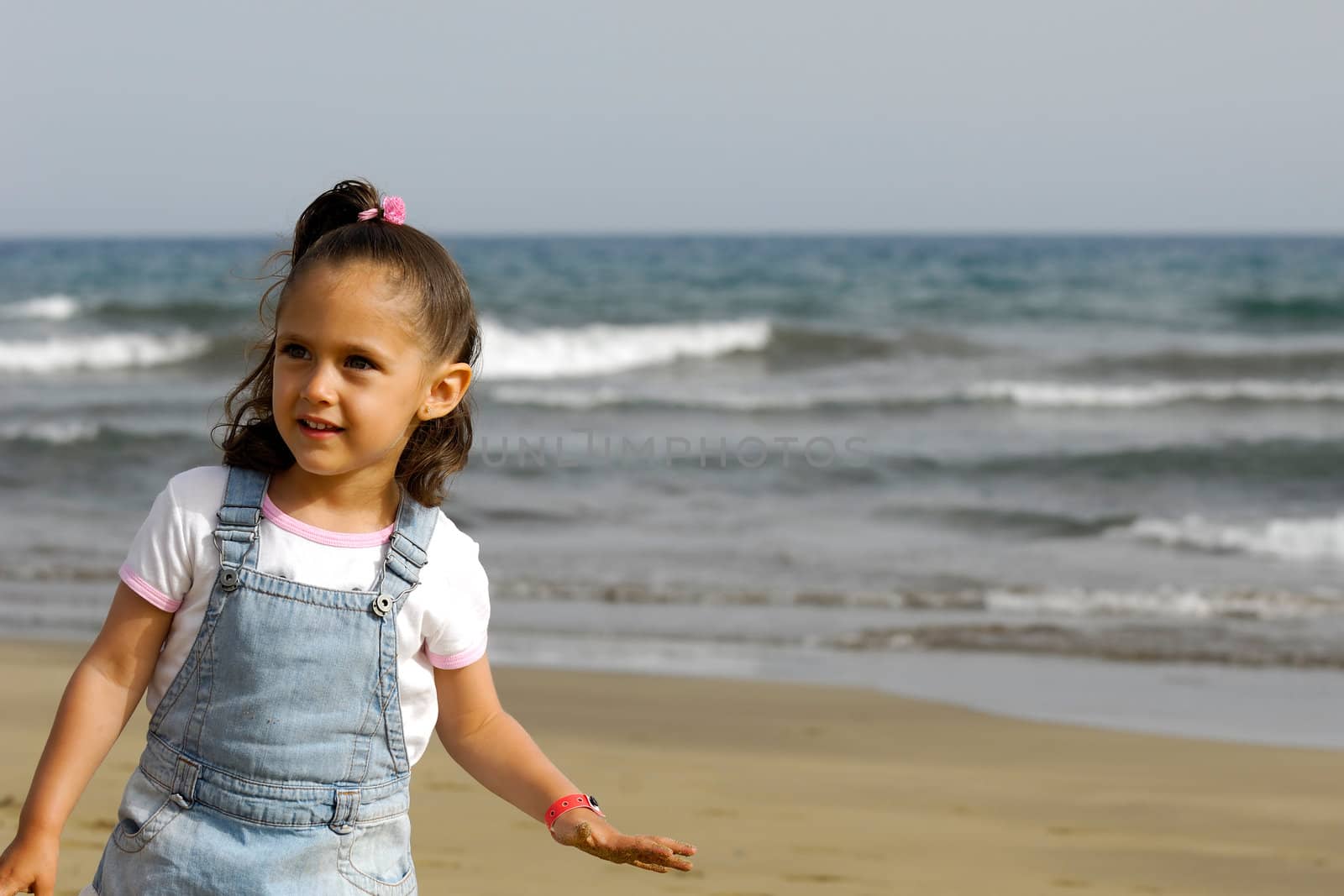 A sweet happy child on the beach.