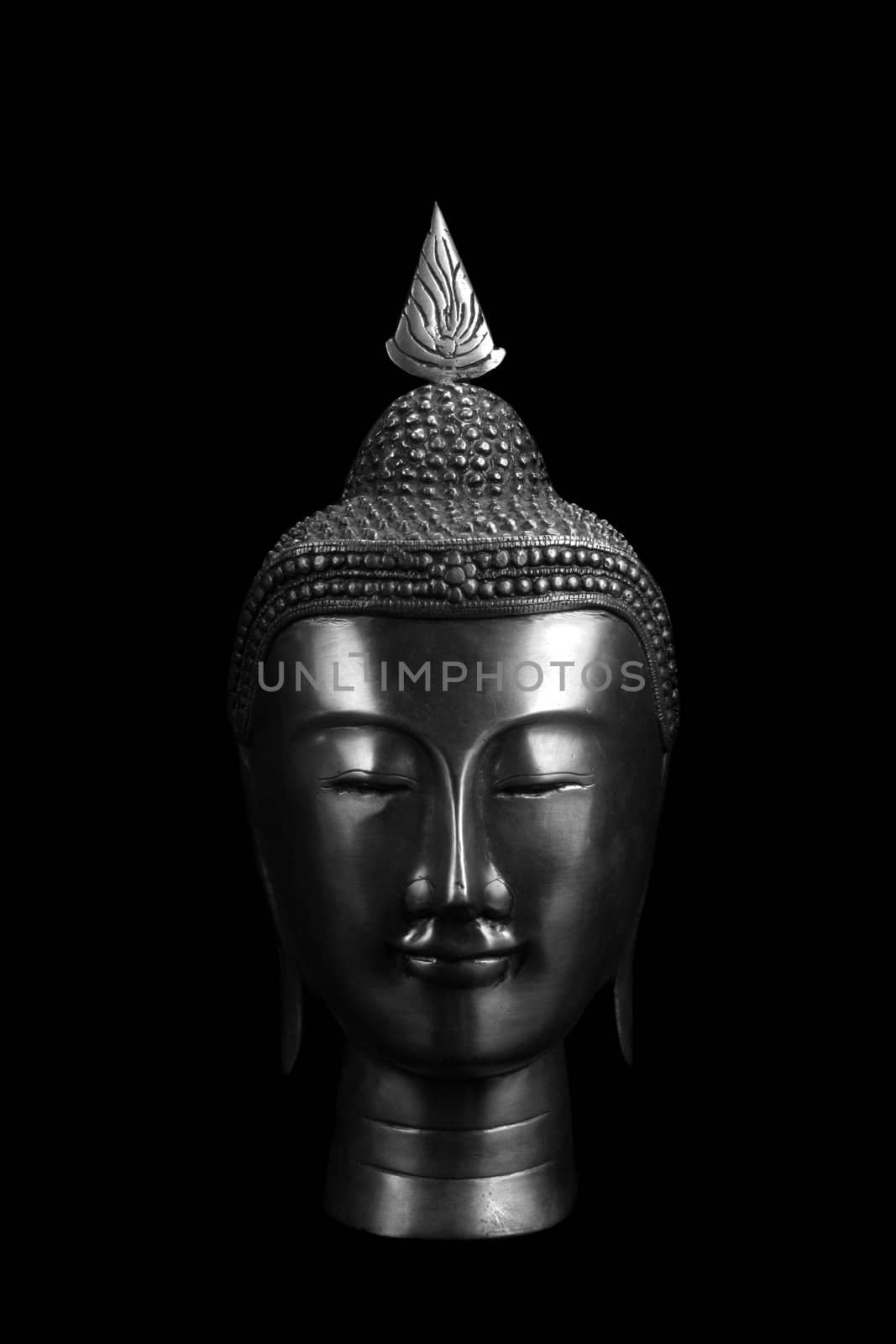 An ancient Buddha artifact, on black background.