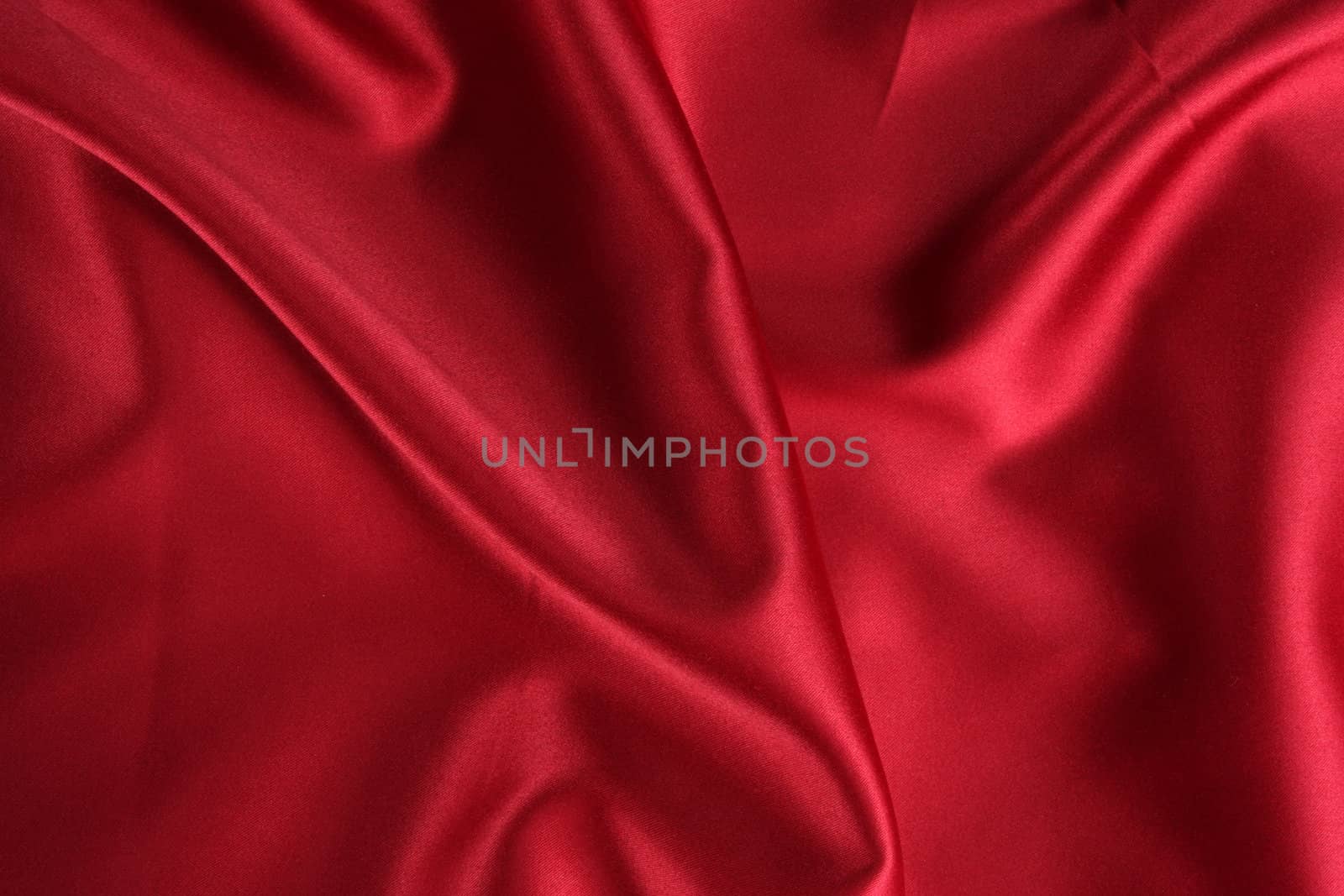 A background of a crumpled red satin cloth.