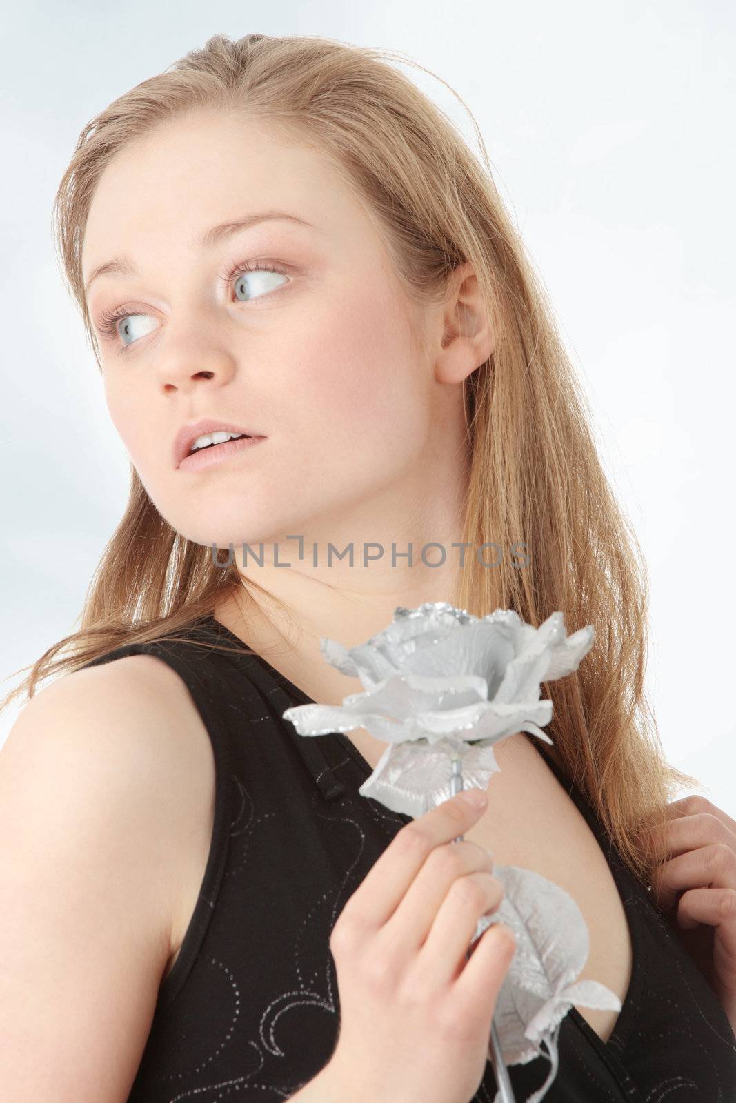 Sensual woman in evening dress with fake silver rose