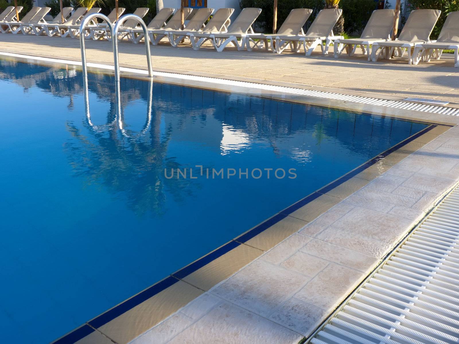 the poolside  and lounge chairs