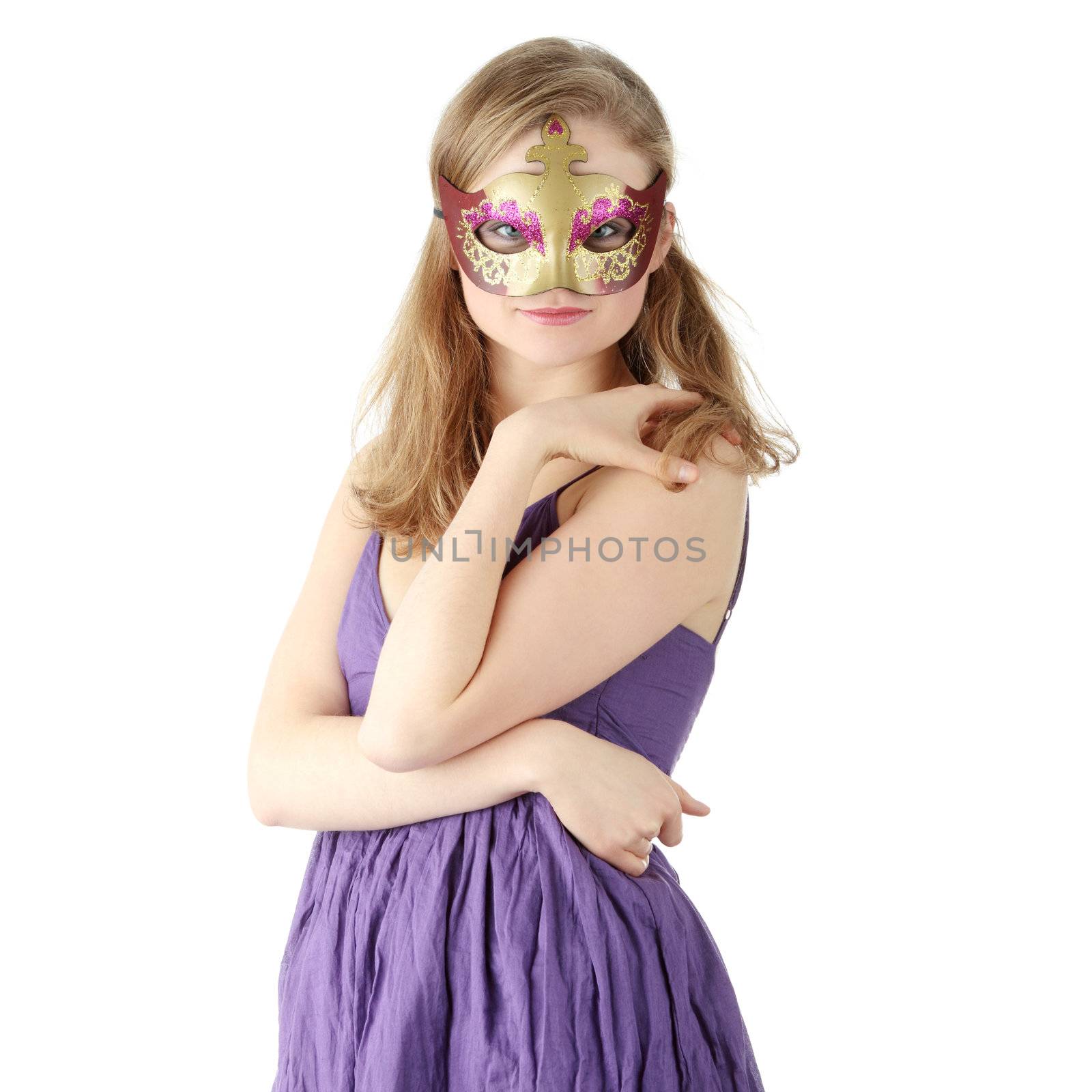 Young beautiful woman in violet dress wearing carnival mask, isolated