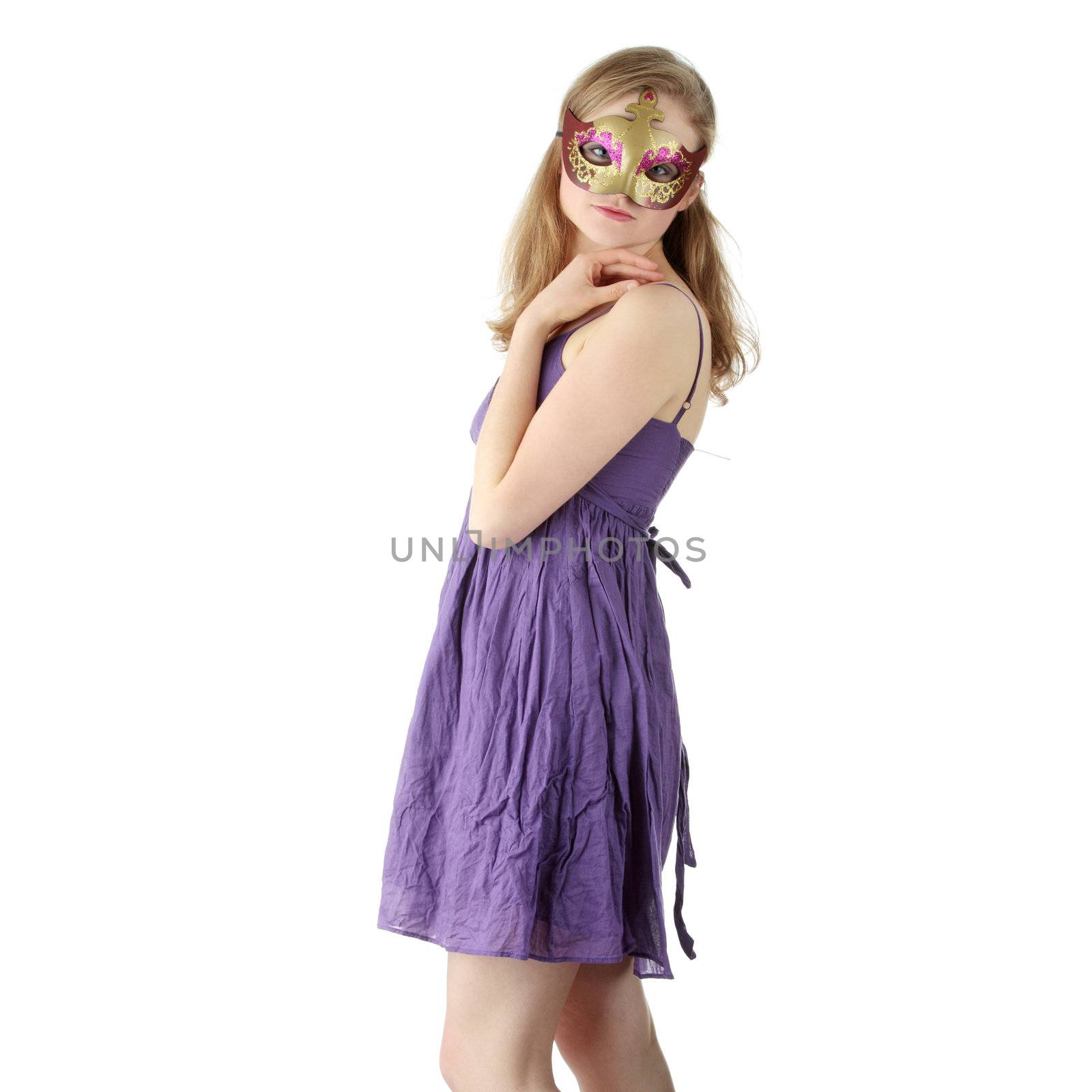 Young beautiful woman in violet dress wearing carnival mask, isolated