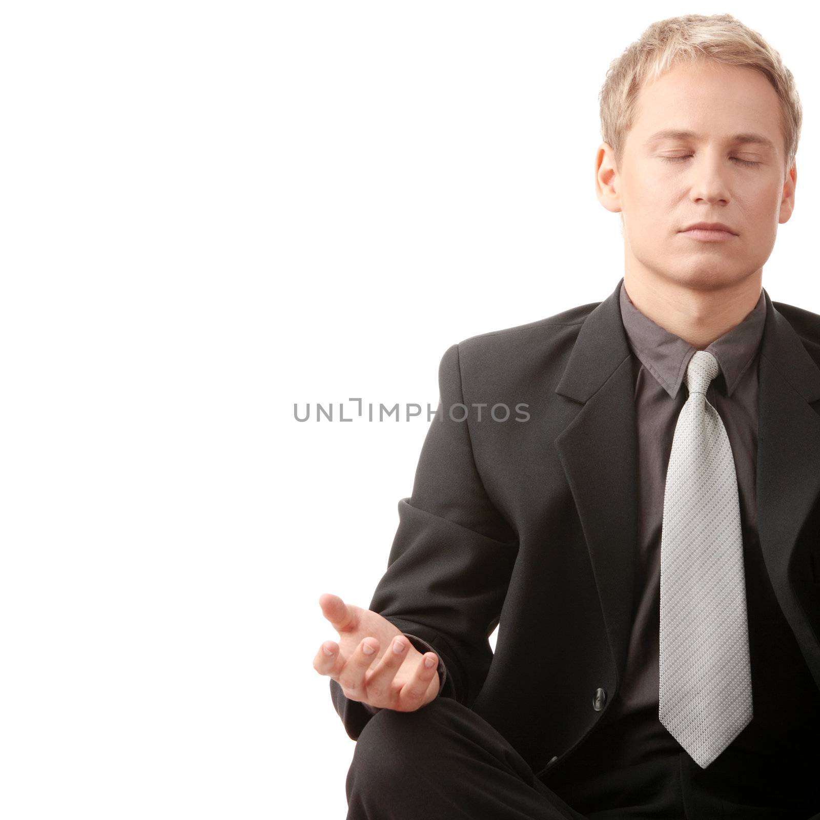 Businessman sitting in lotus position isolated