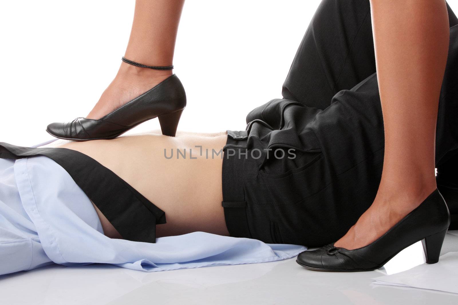 Woman leg on man belly - who is the boss concept