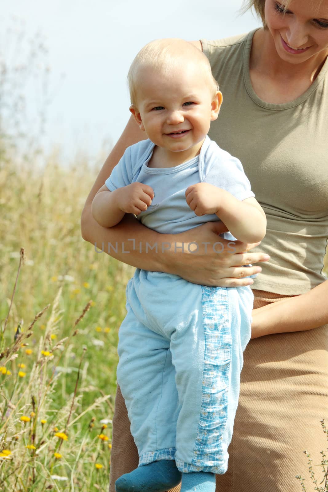 Adorable baby boy outdoors at sunny summer day