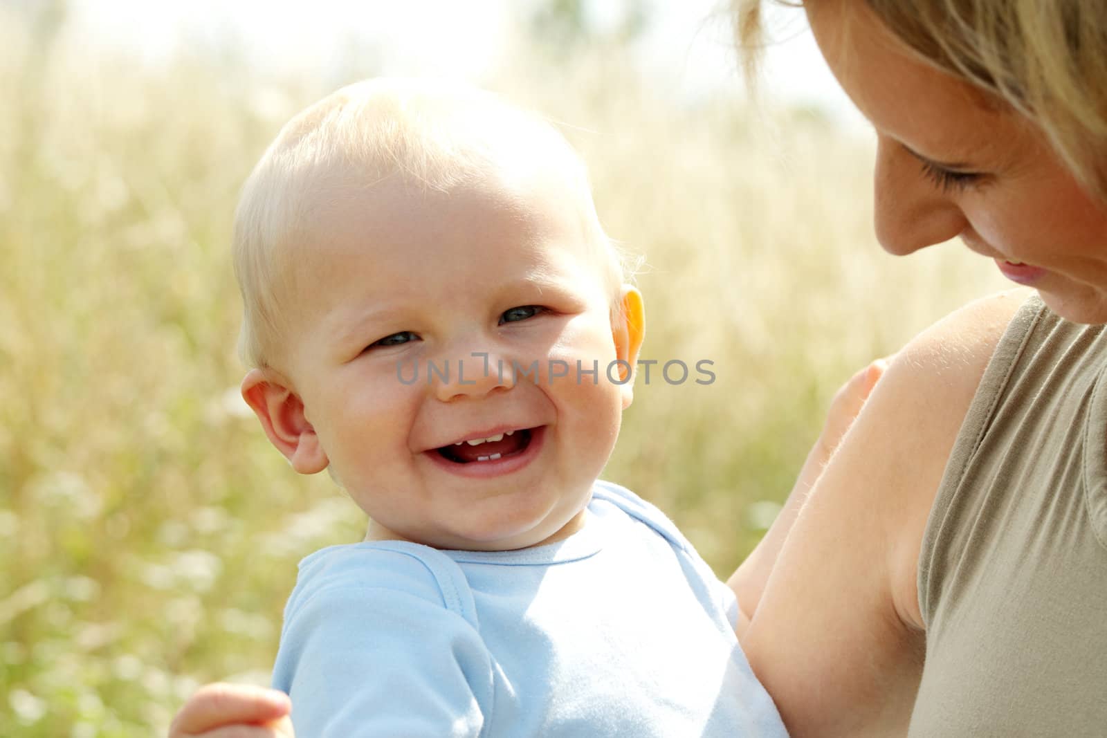 Adorable baby boy outdoors at sunny summer day