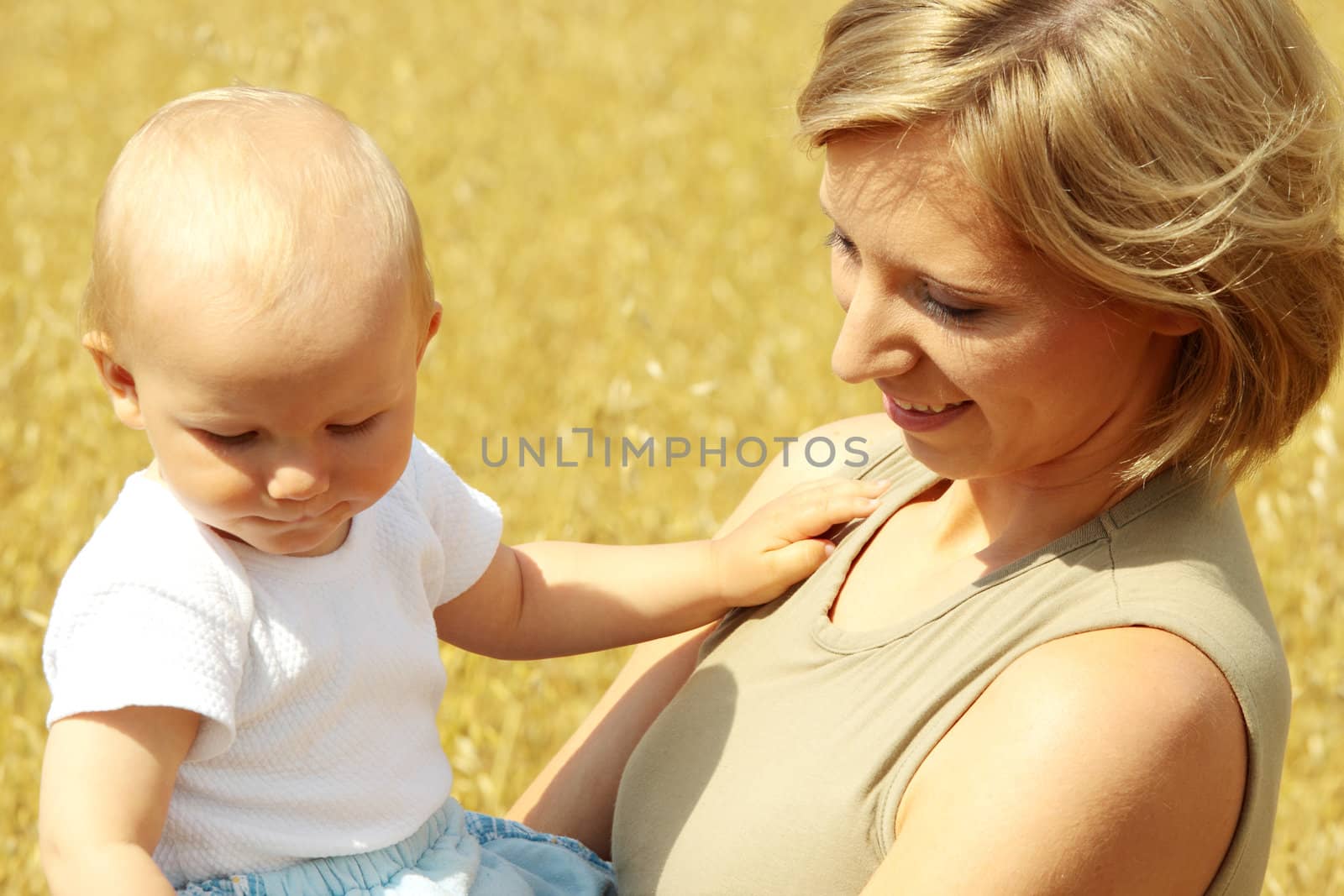 Small baby with mother outdoors. Summer Time.