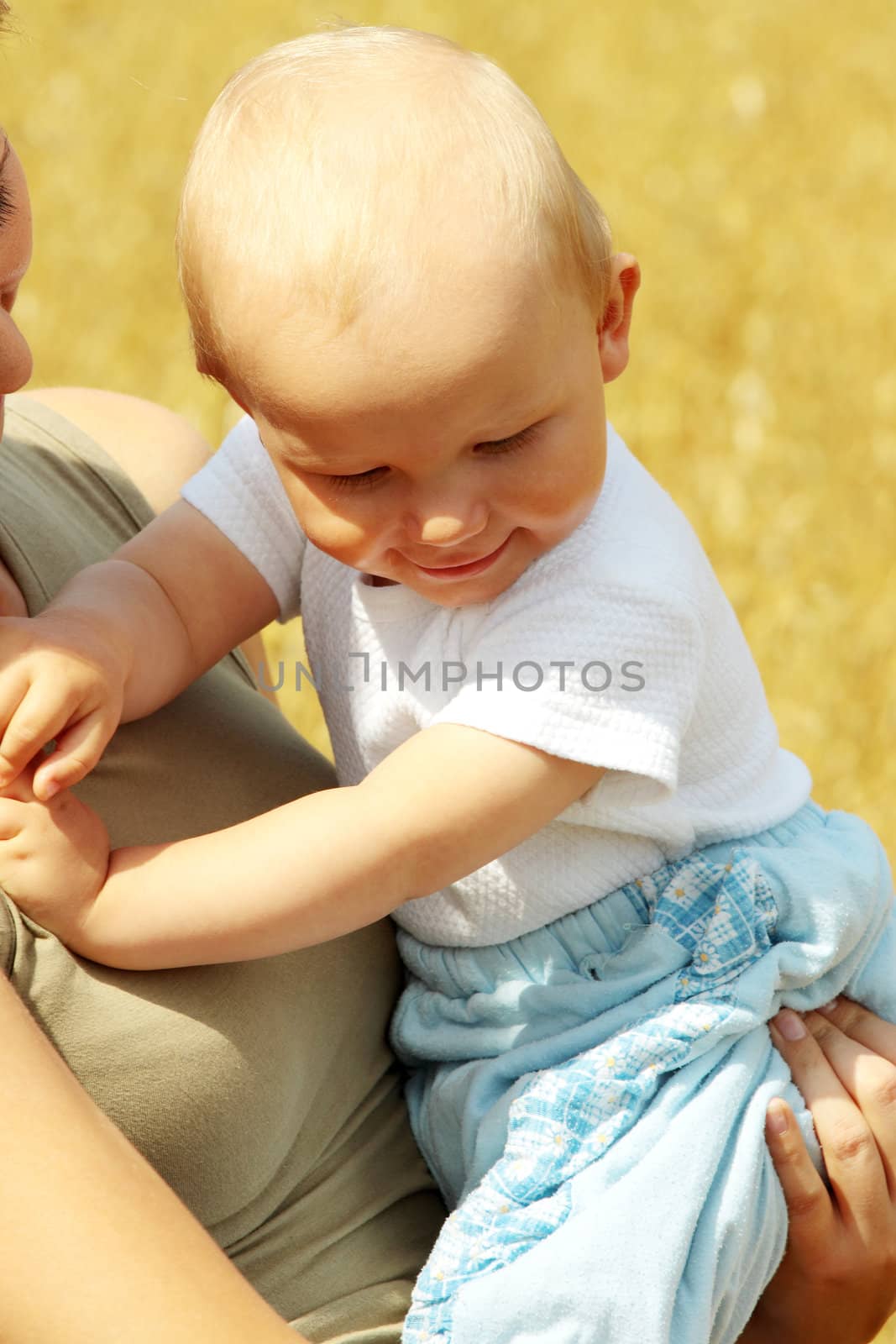 Small baby with mother outdoors by BDS