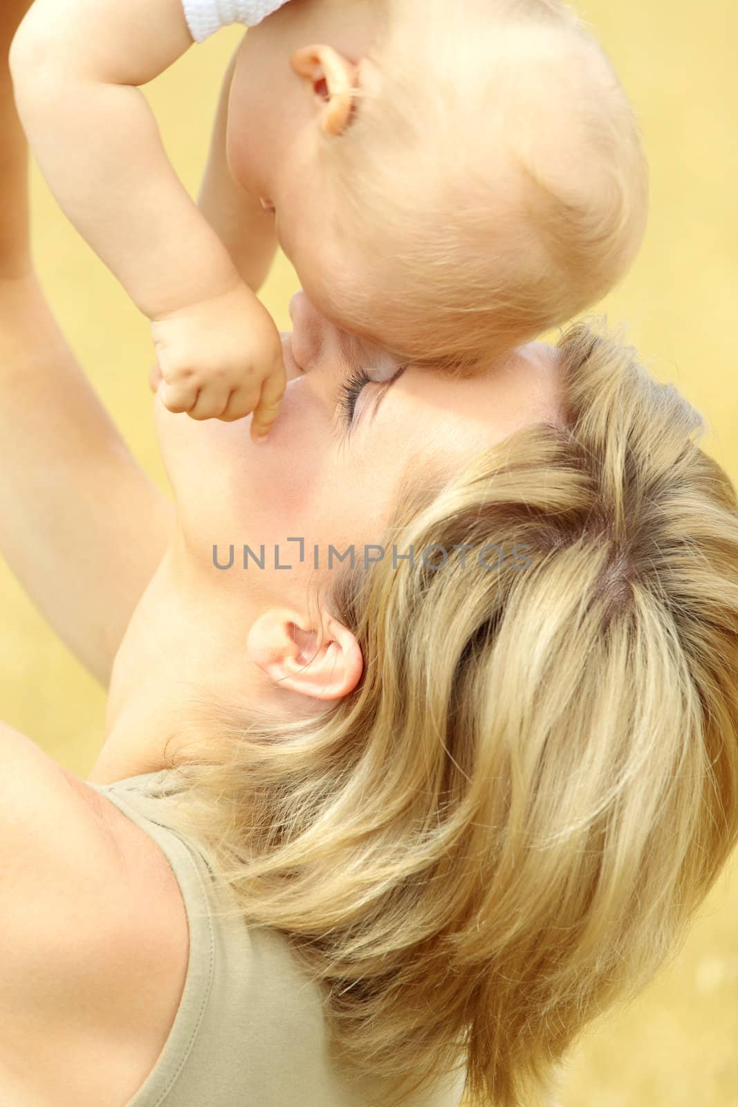 Small baby with mother outdoors. Summer Time.