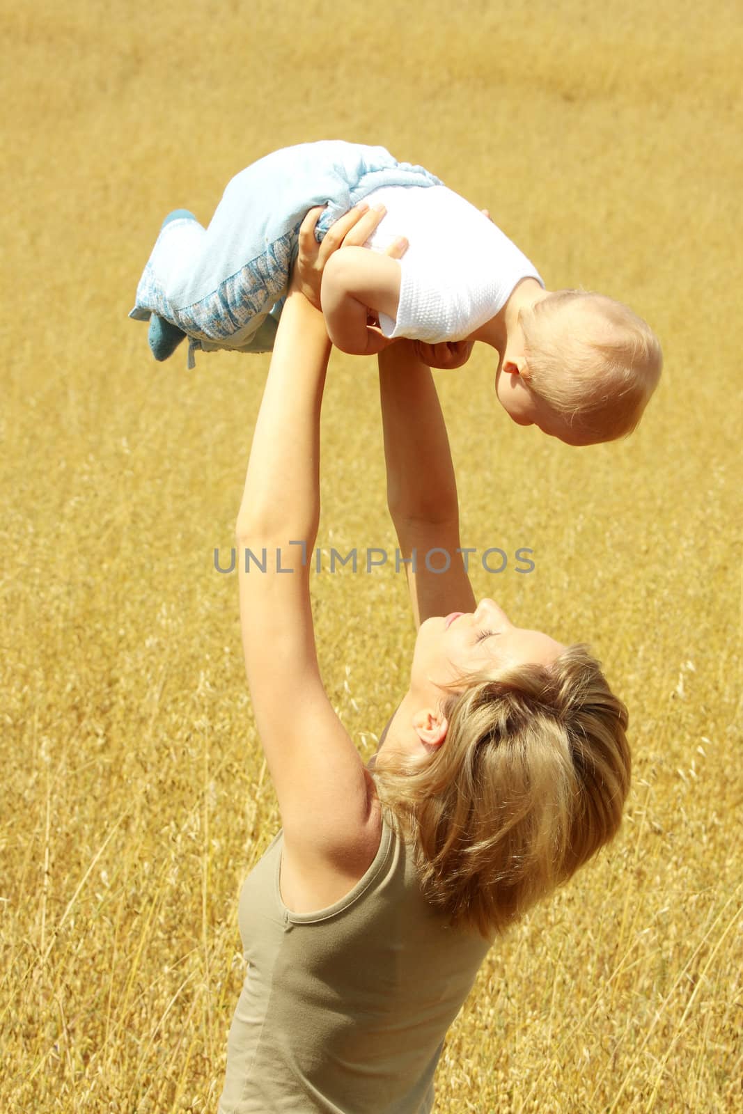 Small baby with mother outdoors. Summer Time.