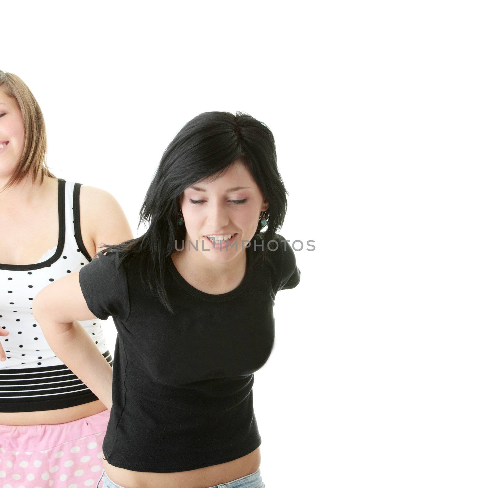 Two teen sisters isolated on white background