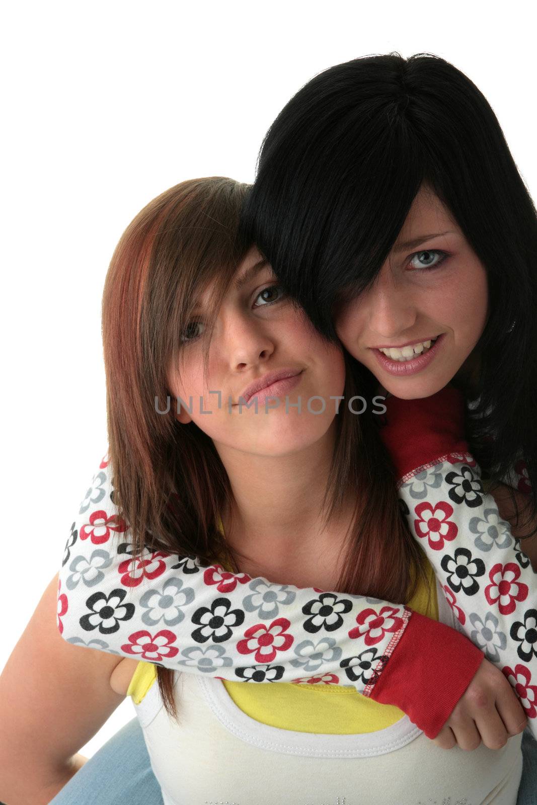 Two teen sisters isolated on white background