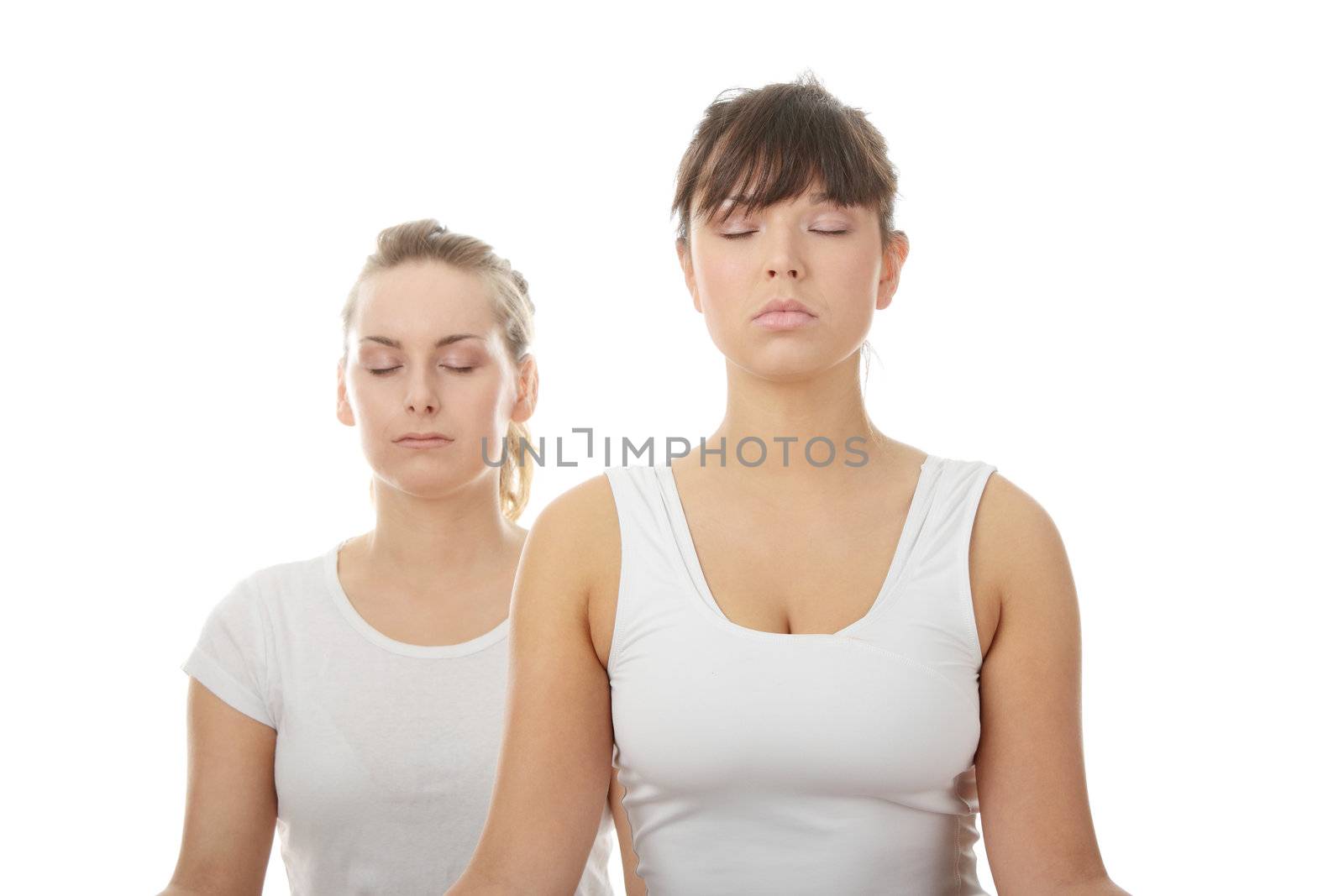 2 Beautiful young womans doing yoga exercise , isolated