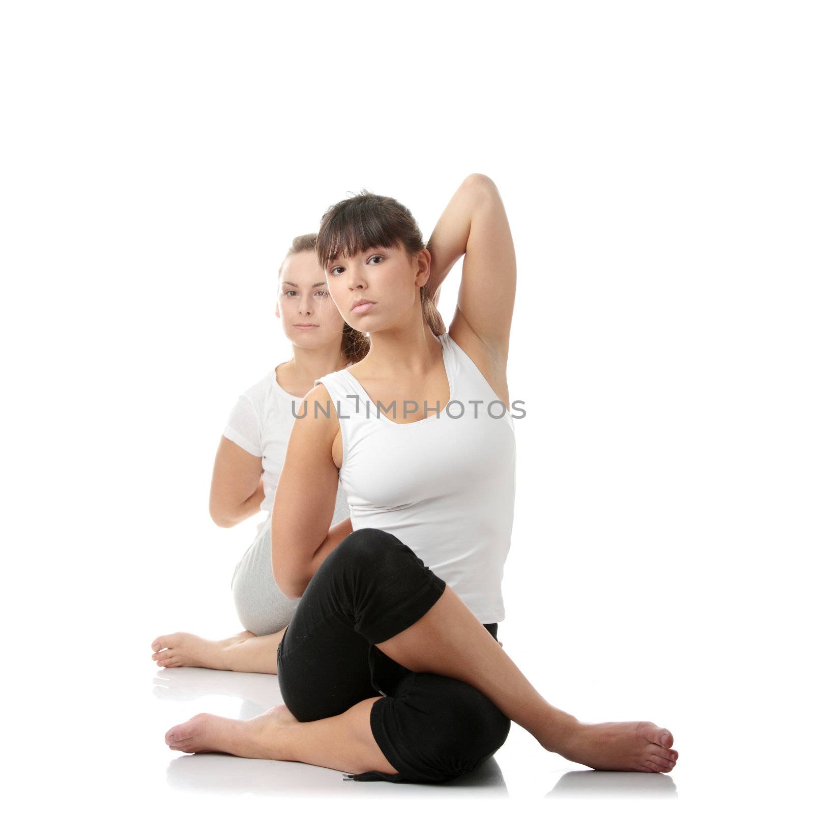 2 Beautiful young womans doing yoga exercise , isolated