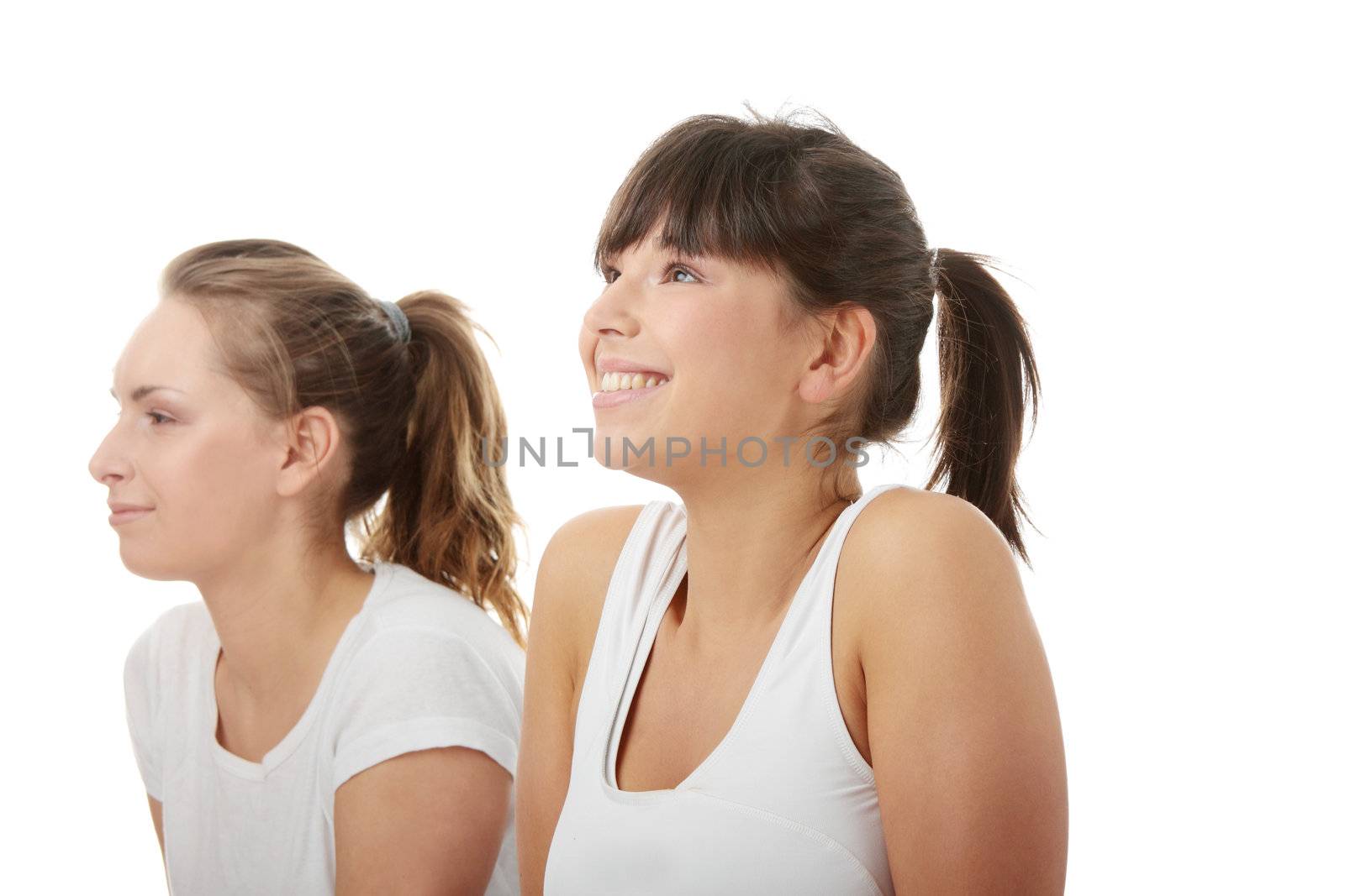 2 Beautiful young womans doing yoga exercise , isolated