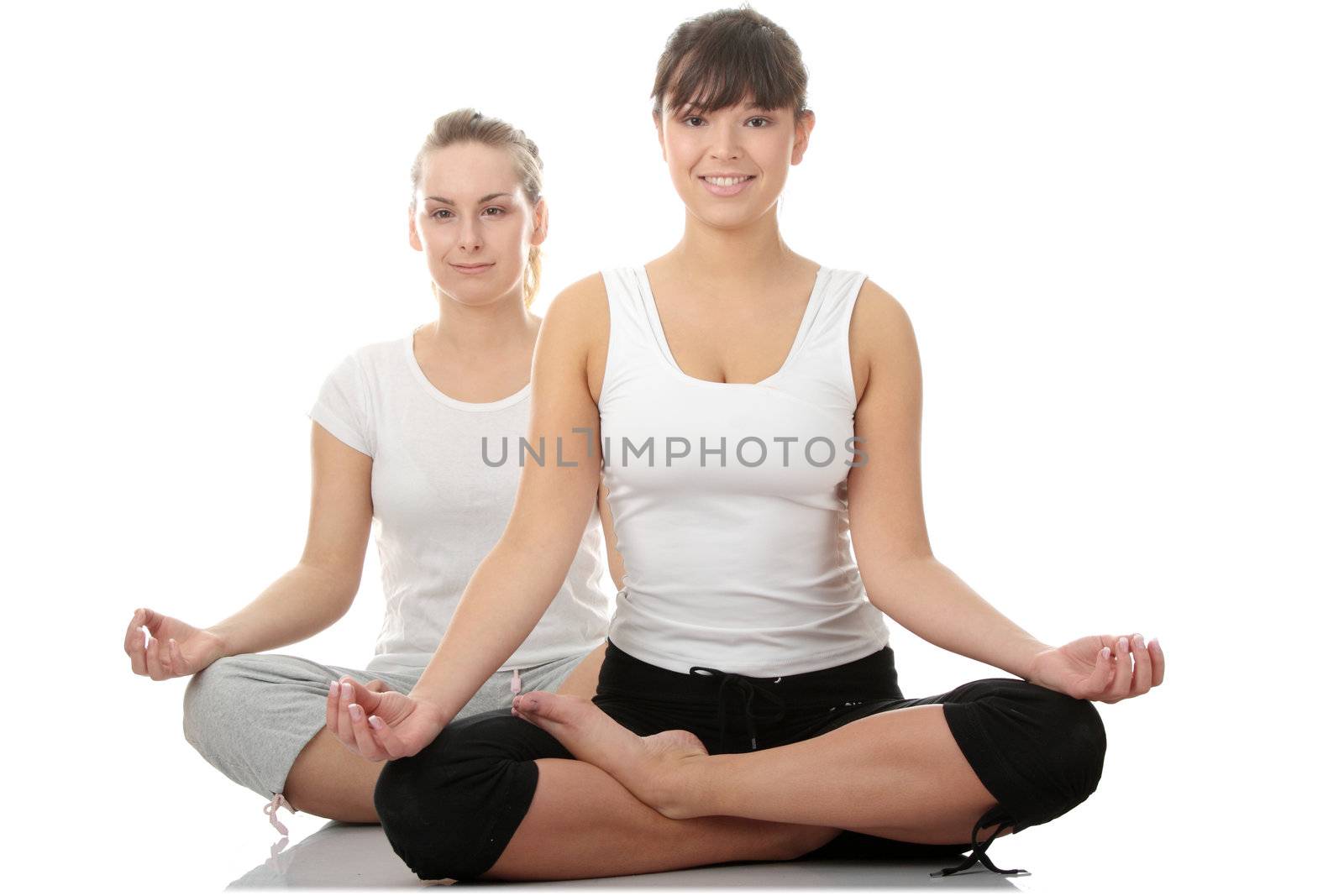 2 Beautiful young womans doing yoga exercise , isolated