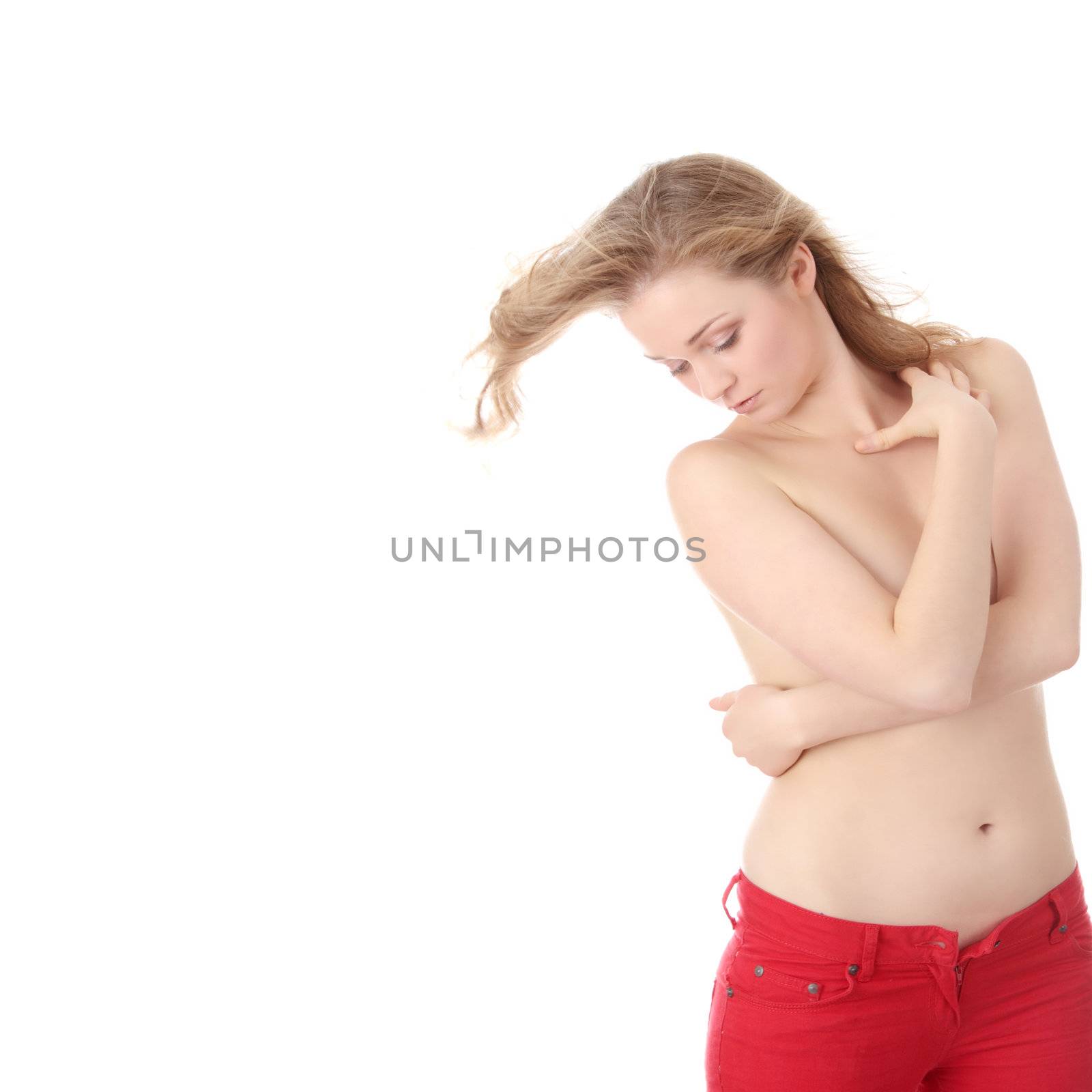 Sensual portrait of young beautiful topless caucasian woman in red jeans. Isolated on white