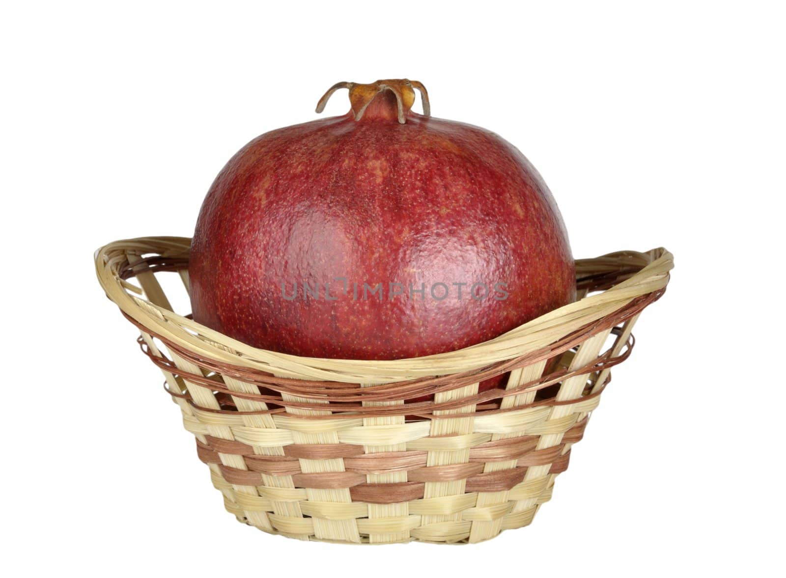 ripe pomegranate in the basket isolated on a white background