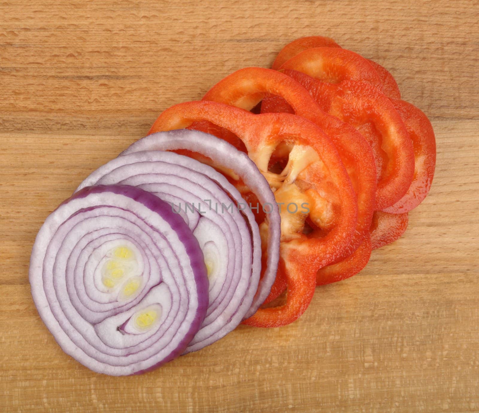 sliced onion and pepper on a wooden board