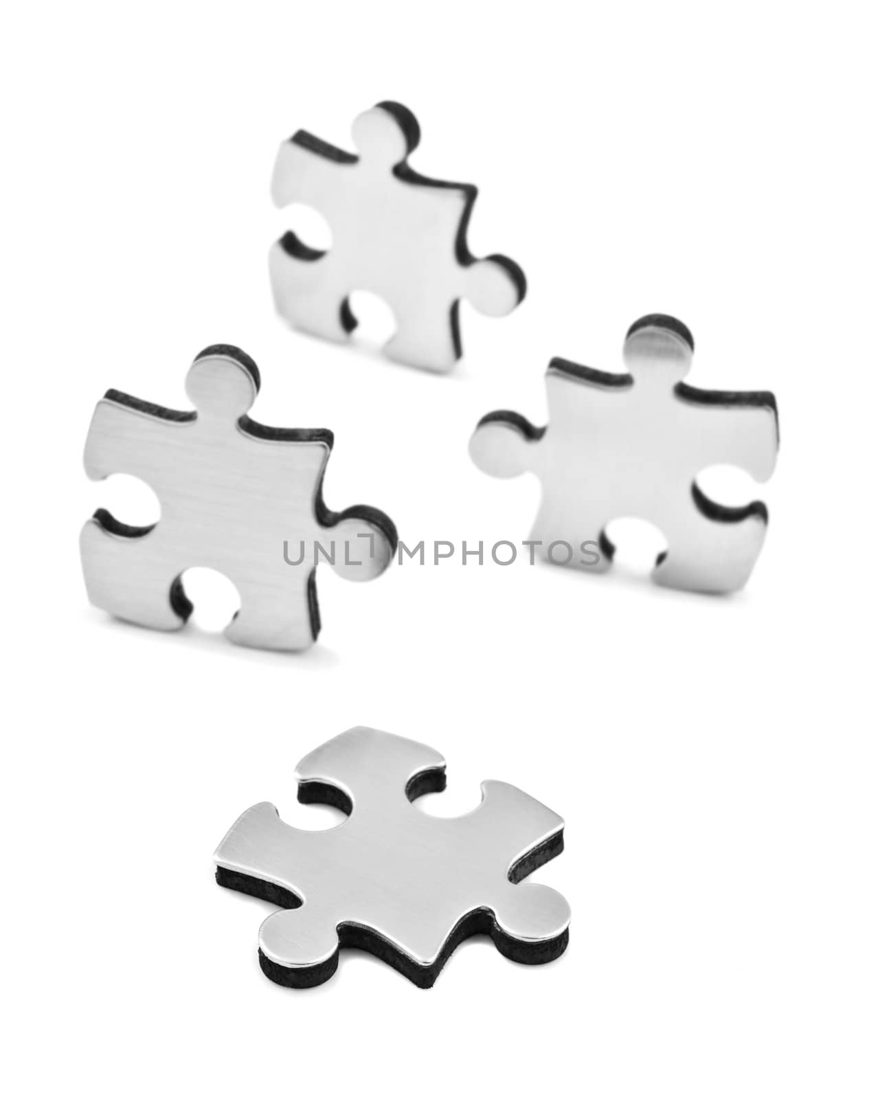 Stainless steel puzzles pieces on white background by tish1
