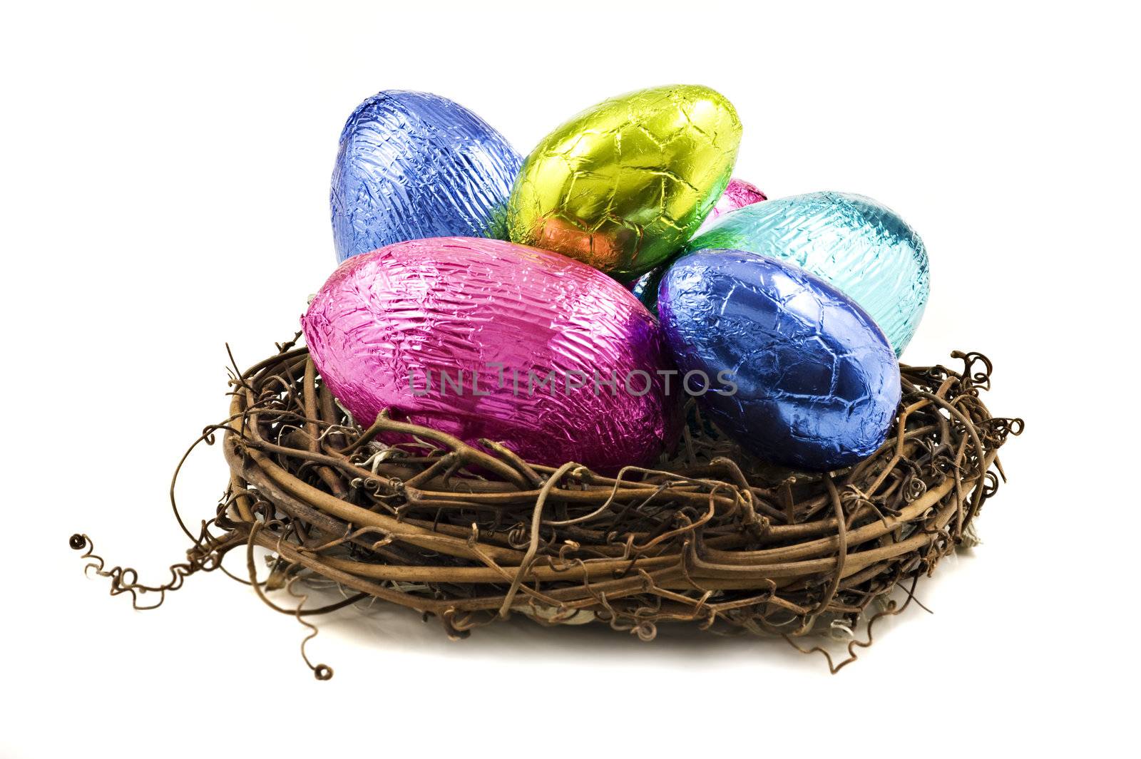 Colorful easter eggs in a nest on a white background