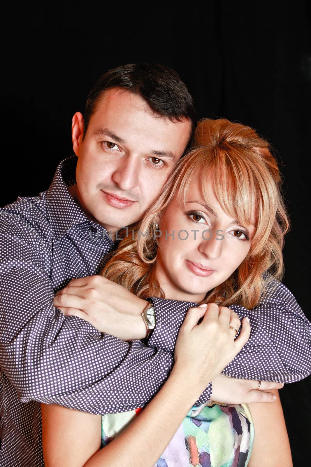 Couple in love smiling. Over black background