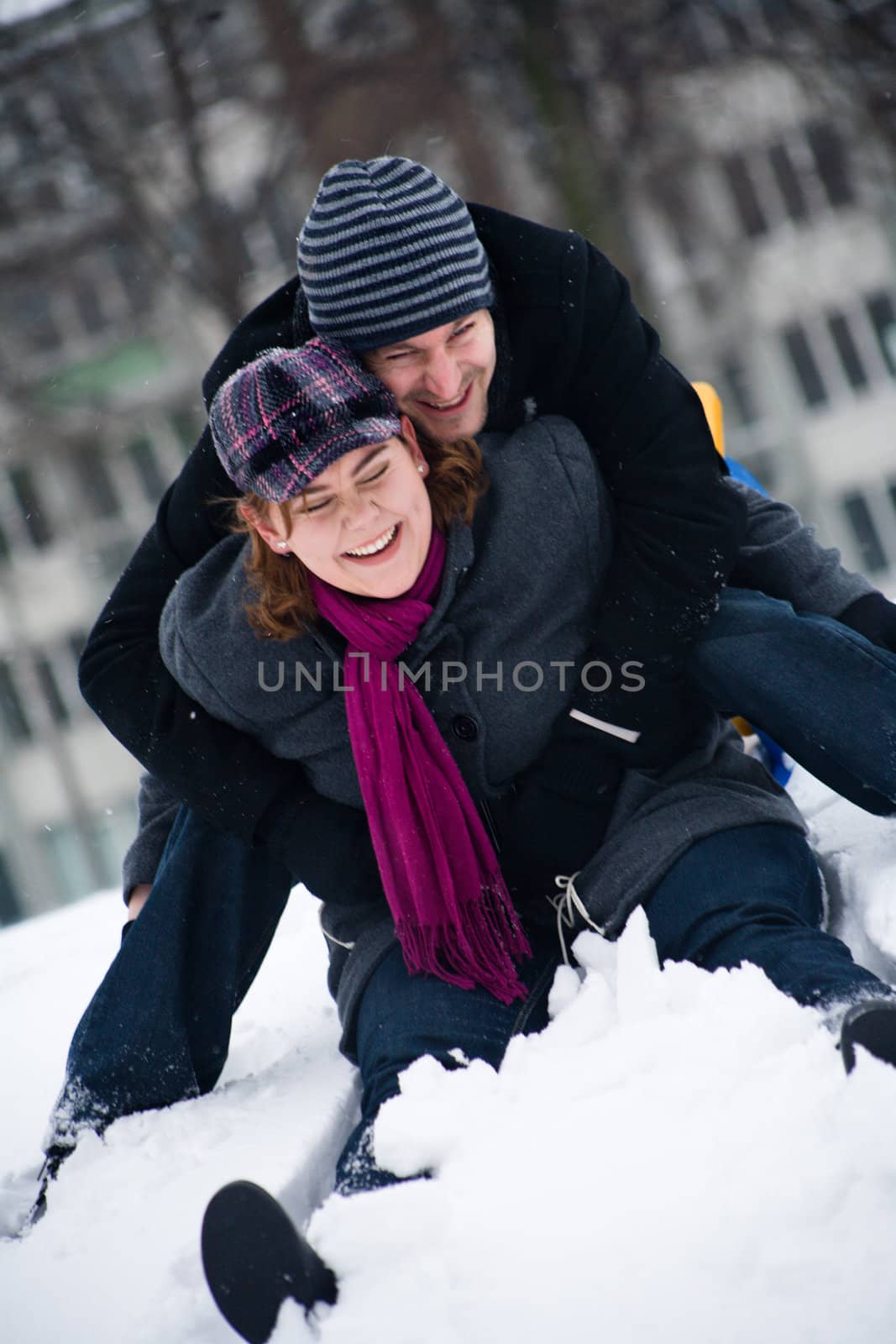 Happy couple in the snow having some fun together