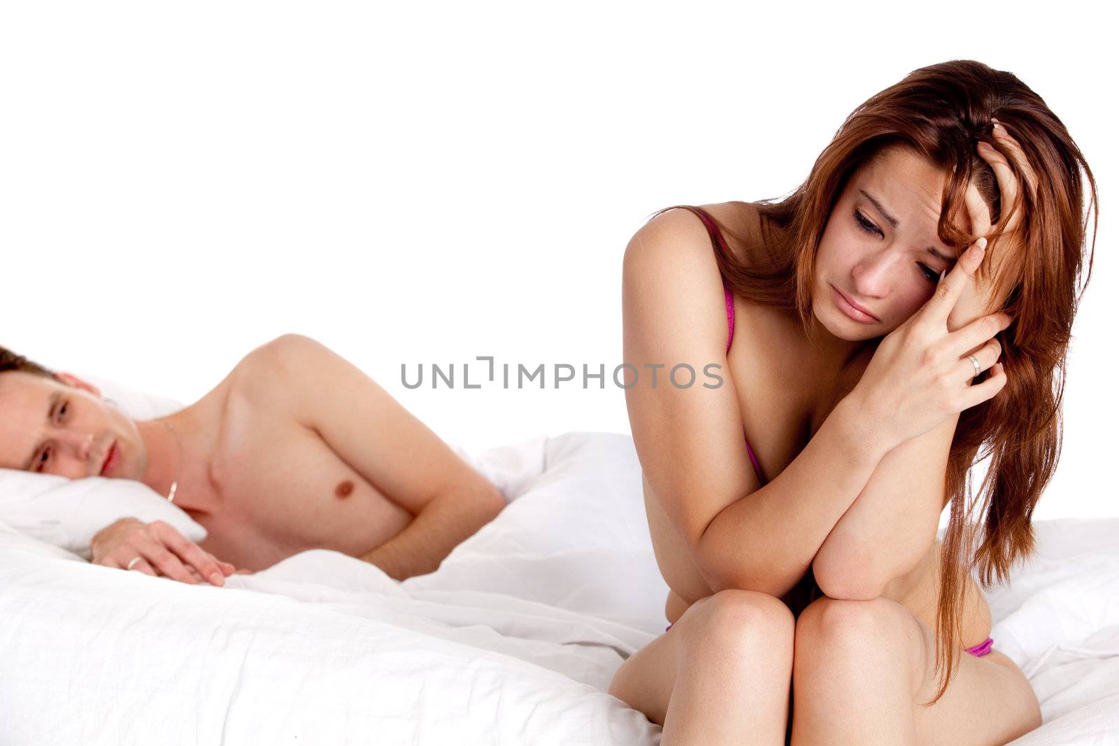 Young couple on a bed with emotions