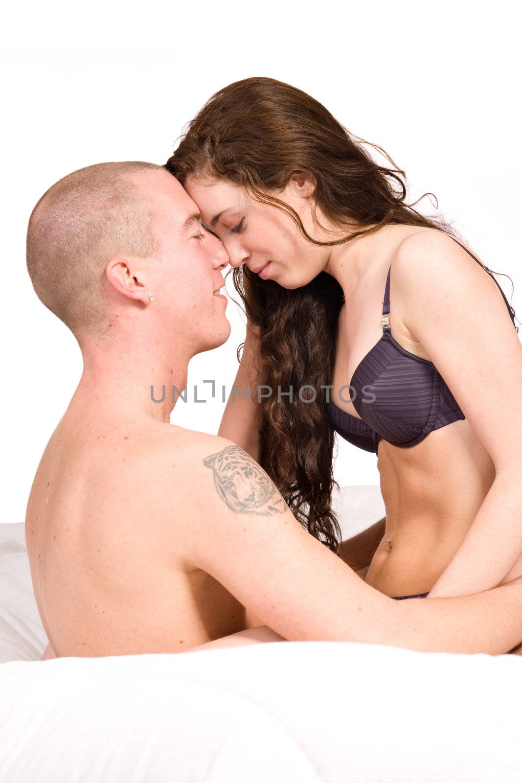 Young couple sitting up in bed fondling by DNFStyle