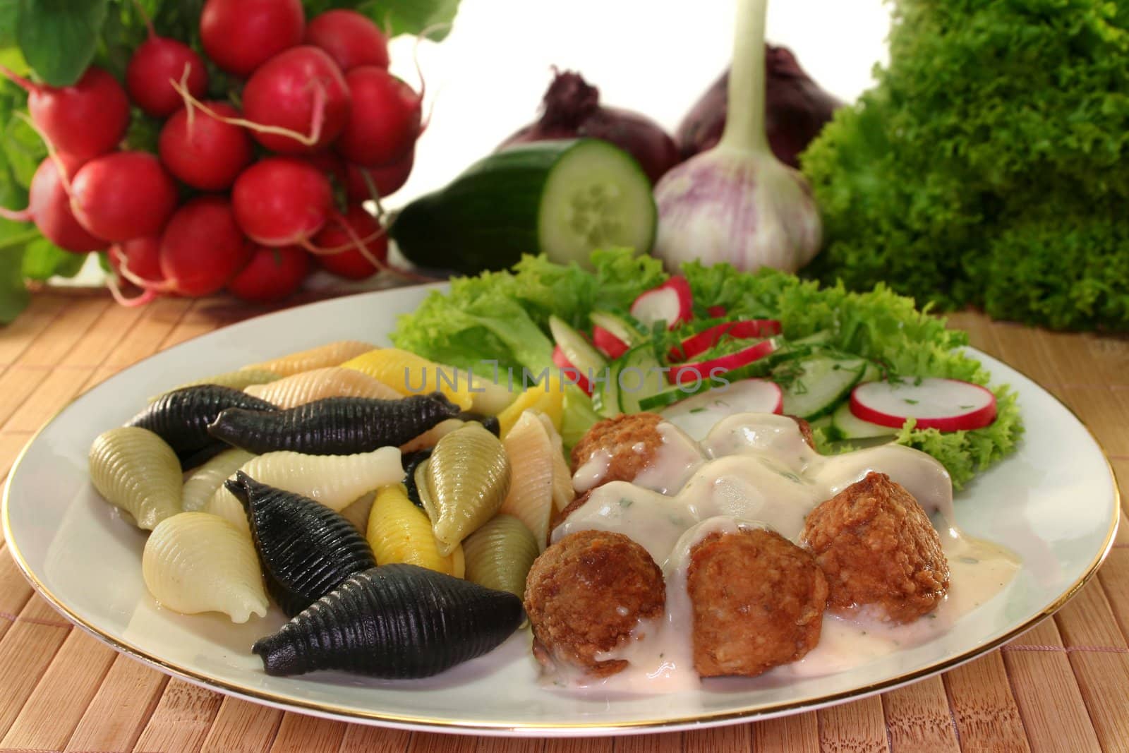 Swedish meatballs with noodles and radish-cucumber salad