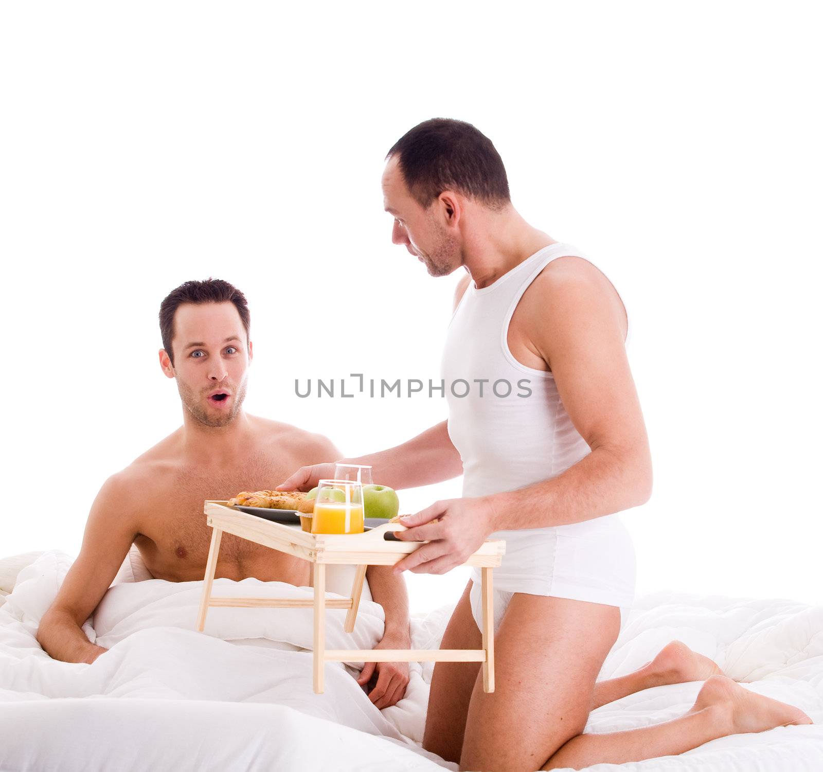 A Happy homo couple and their breakfast on a tray in bed