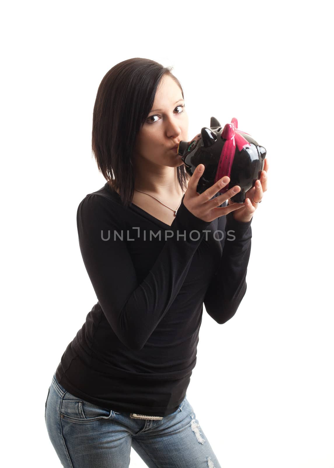 a young woman kissing a piggy bank isolated on white