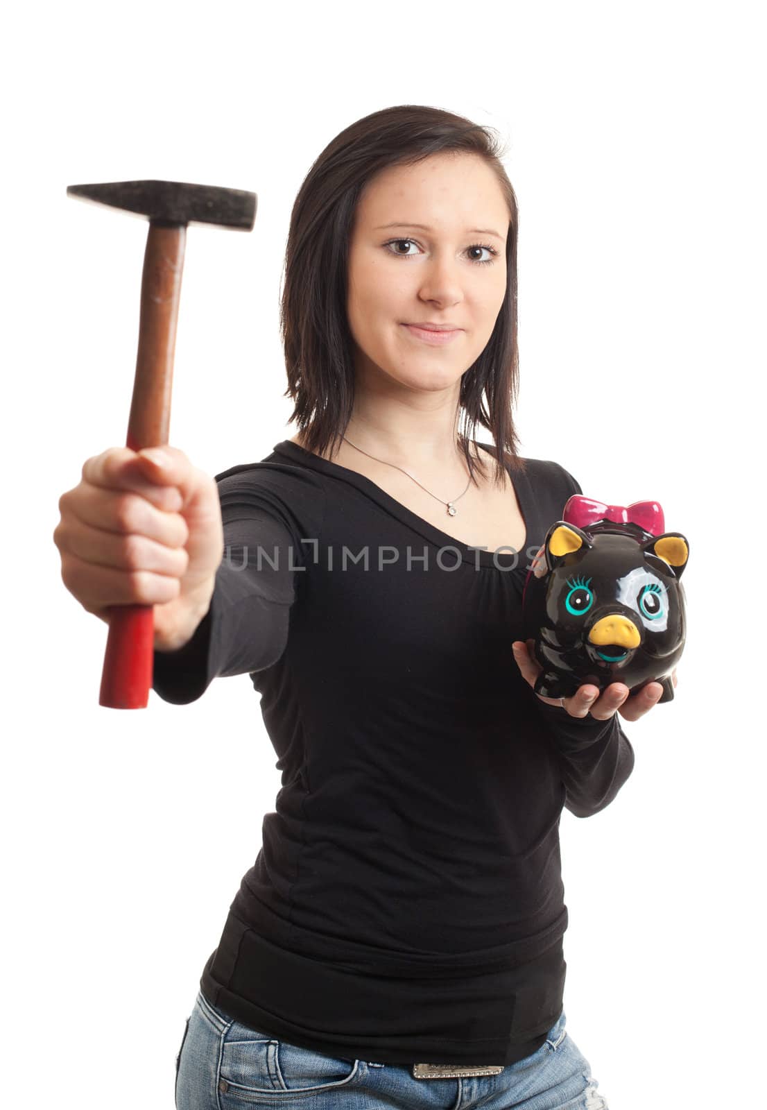 a young woman holding a piggy bank and a hammer isolated on white