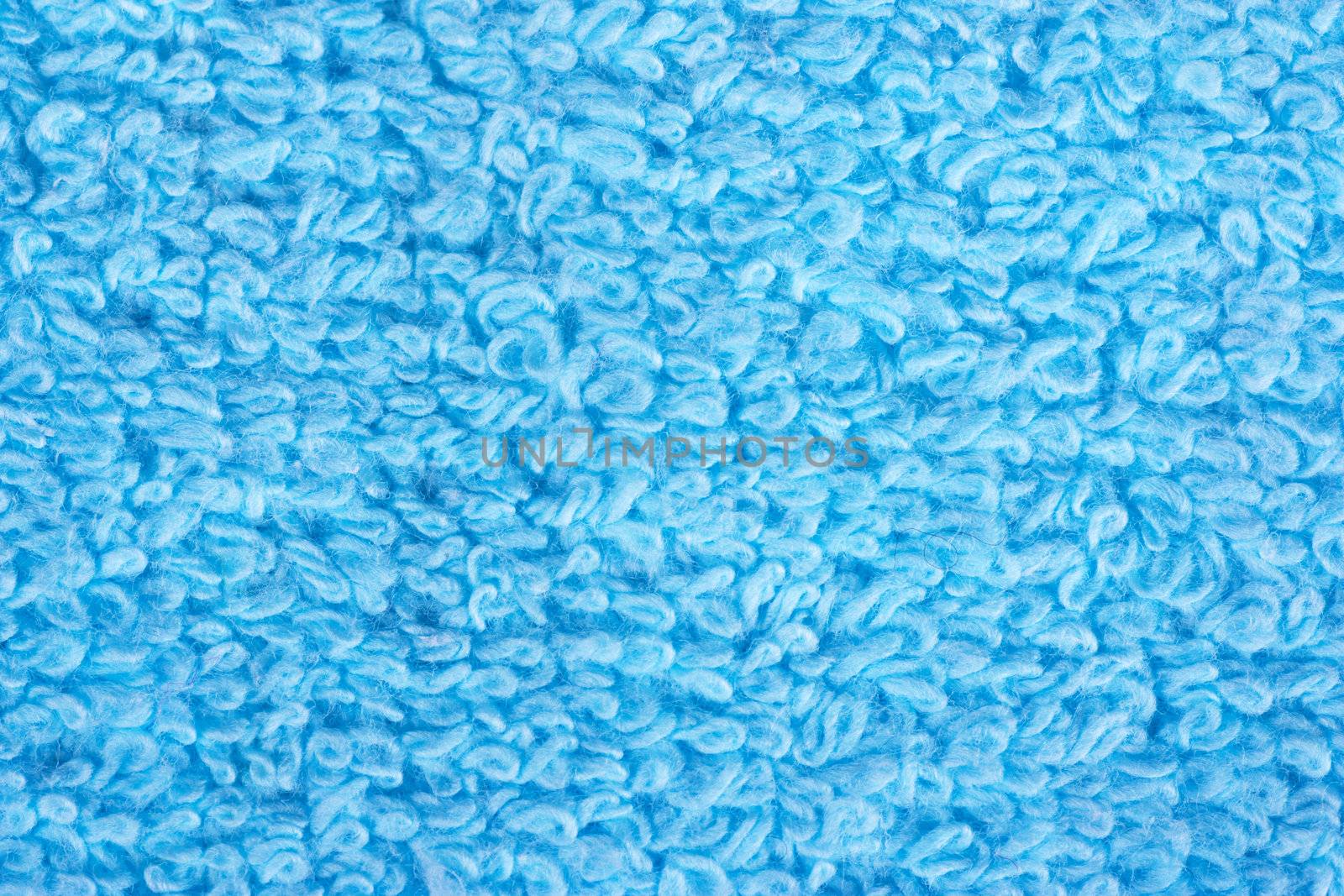 Closeup view of blue towel. Fluffy blue background