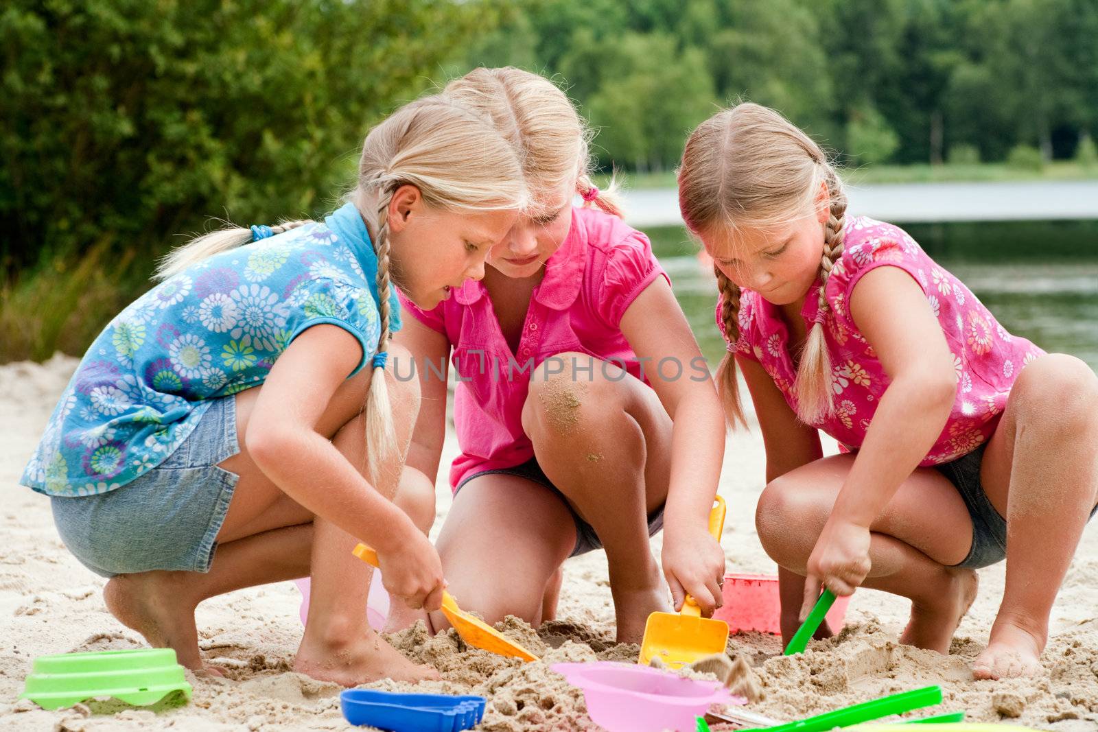 The girls digging in the sand by DNFStyle