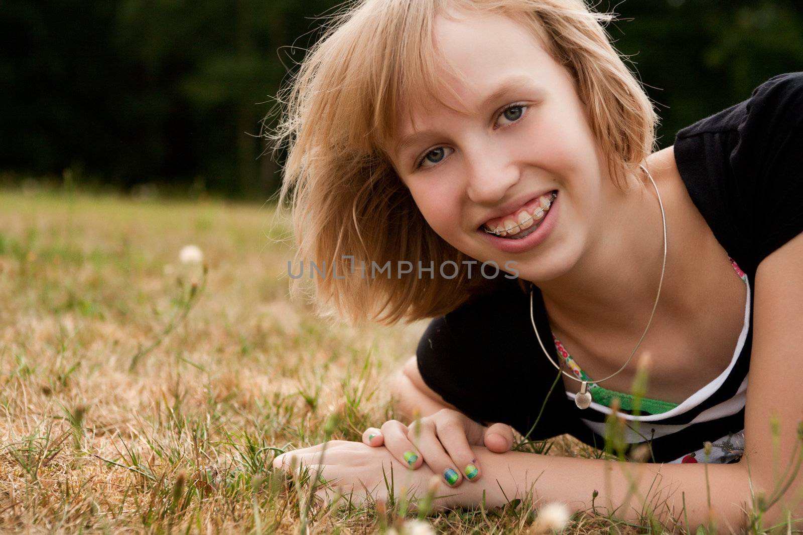 Young summer girl portrait in the grass