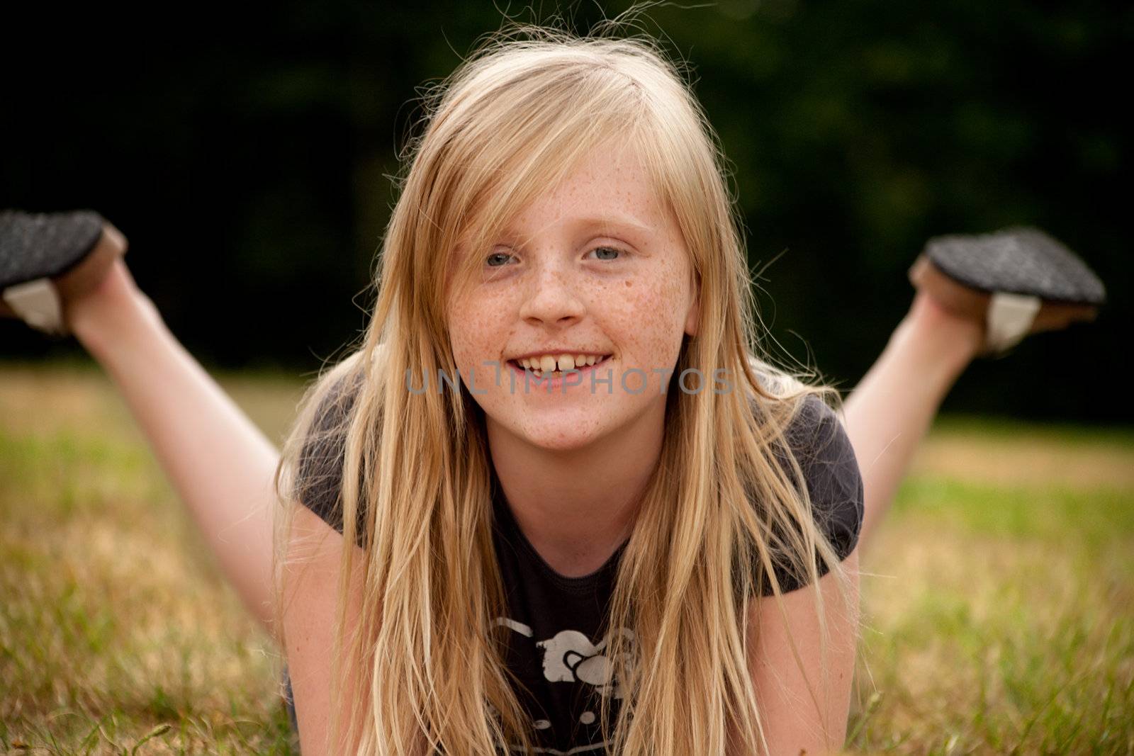 Young summer girl portrait in the grass