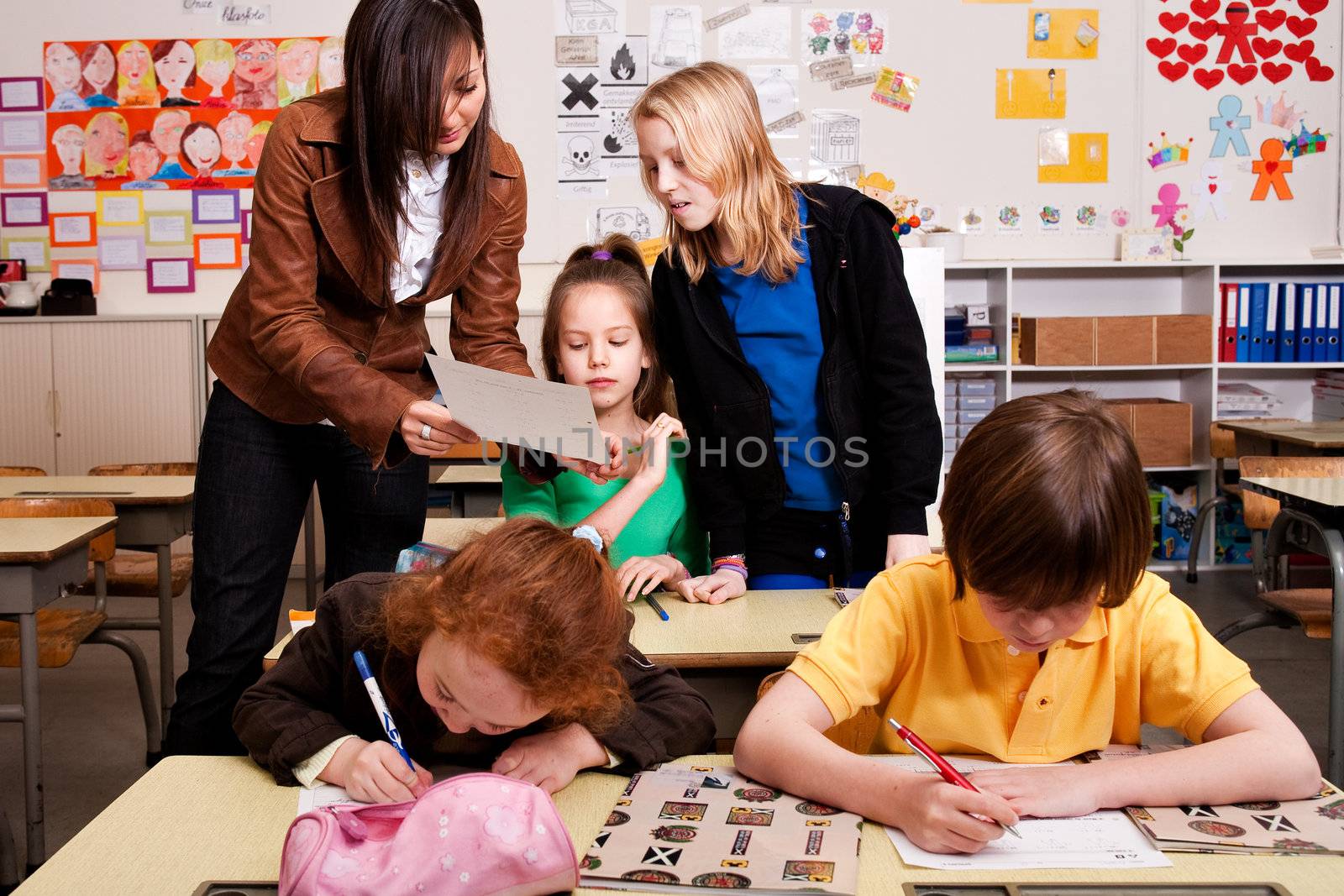 Group of little students with different ages in a classroom