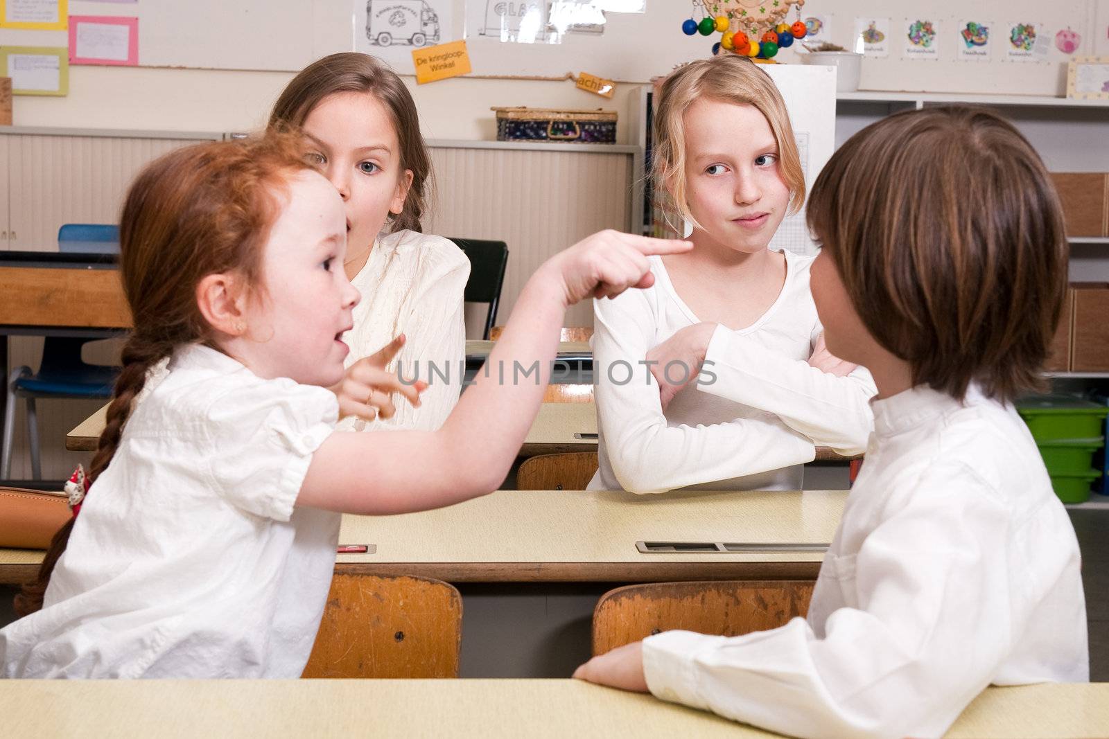 Group of little students with different ages in a classroom