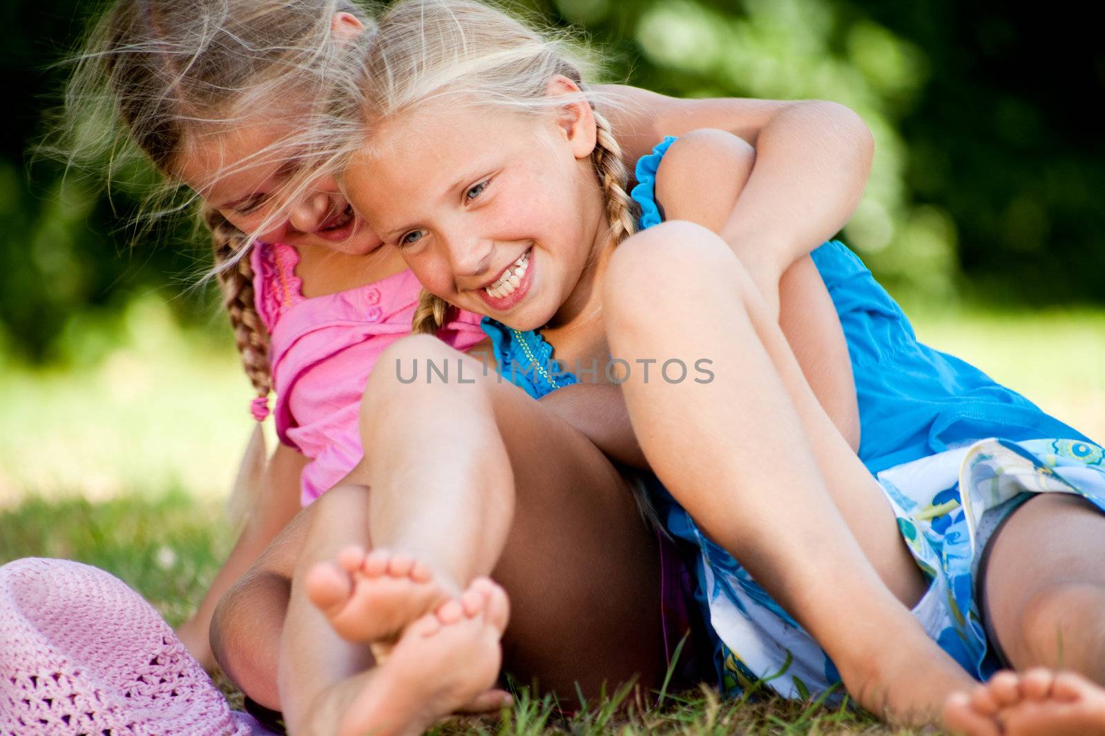 Two little girls in fresh colors in the park